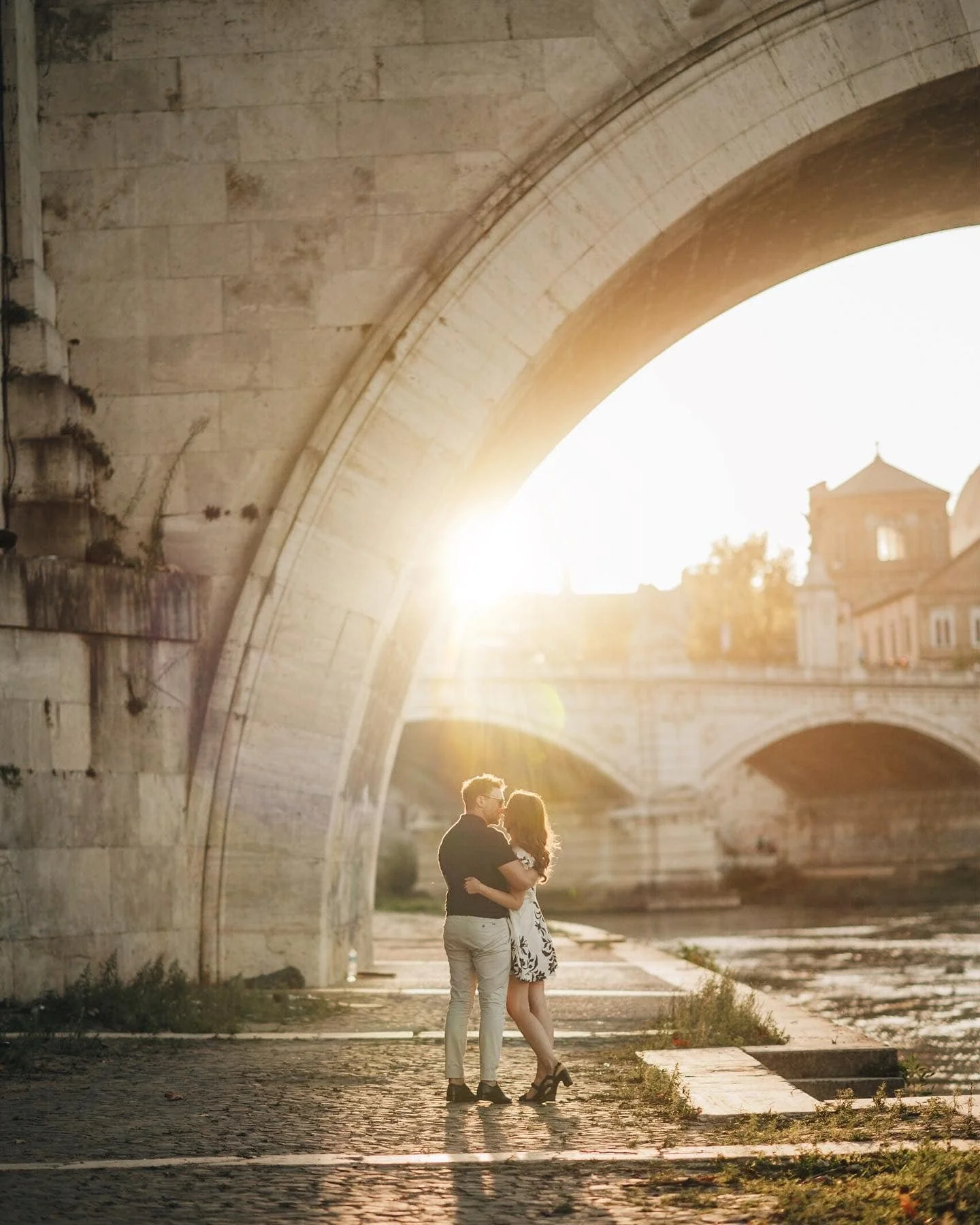 backlit sunset photo of a couple under a bridge on their yorkshire on their pre-wedding photoshoot