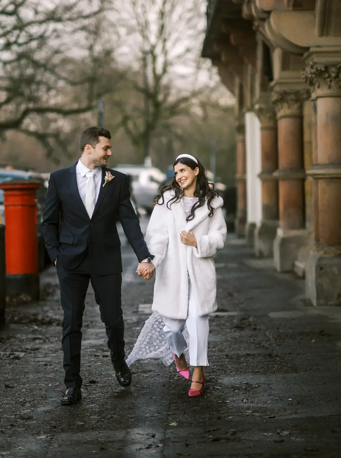 newly married couple walking down harrogate street holding hands and smiling.  taken by harrogate wedding photographer Yorkshire Portraits