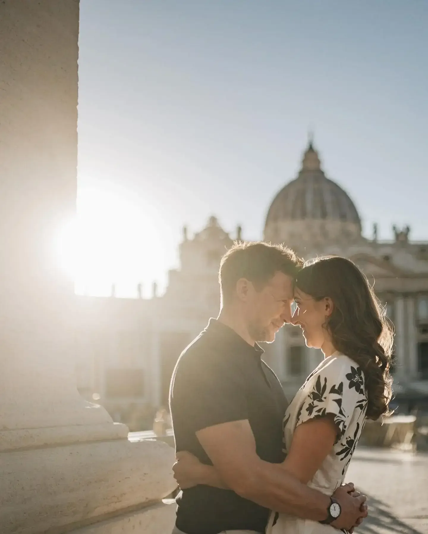 engaged couple cuddling on a glorious sunny night on their on their Rome pre-wedding photoshoot