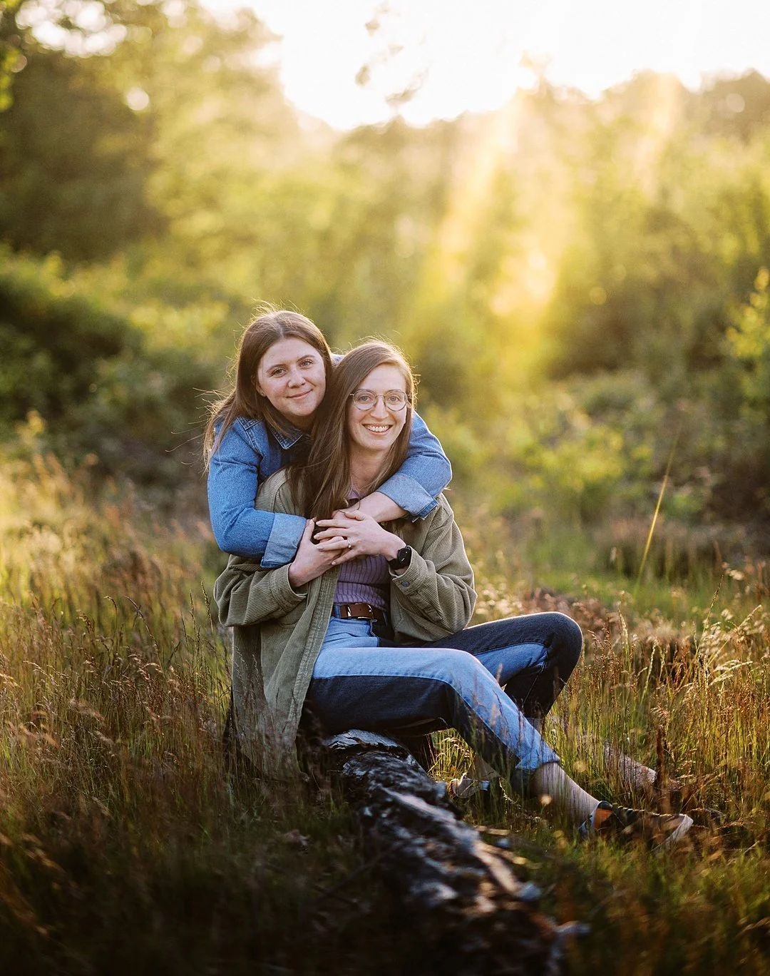 Lesbain couple embracing on a sunny evening on an engagement photoshoot at clumber park