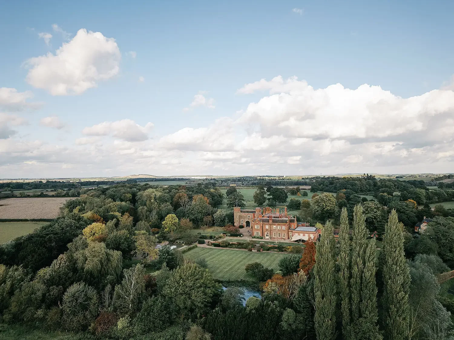 drone photo showing a beautulf blue sky view of hodsock priory on an autumn day for a wedding