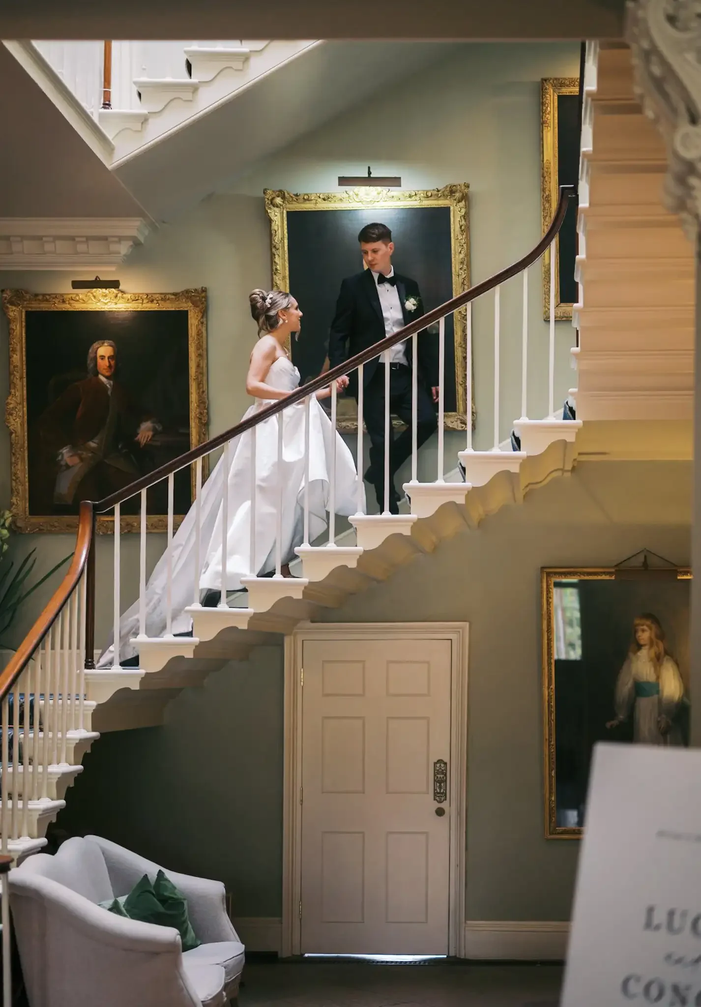 staircase at norwood park wedding with bride and groom walking up and looking at each other