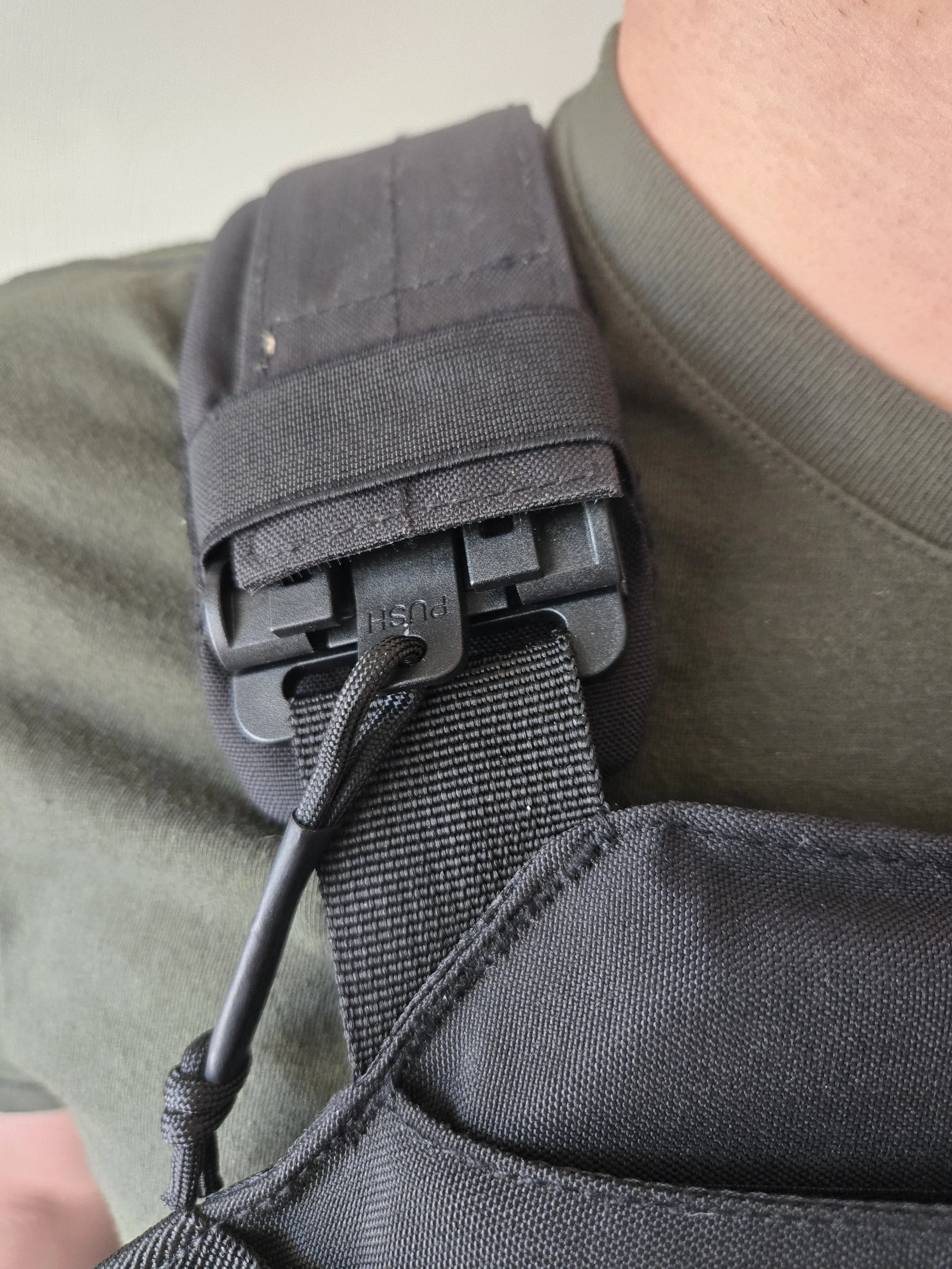 Close-up of plate carrier shoulder buckle quick-release system