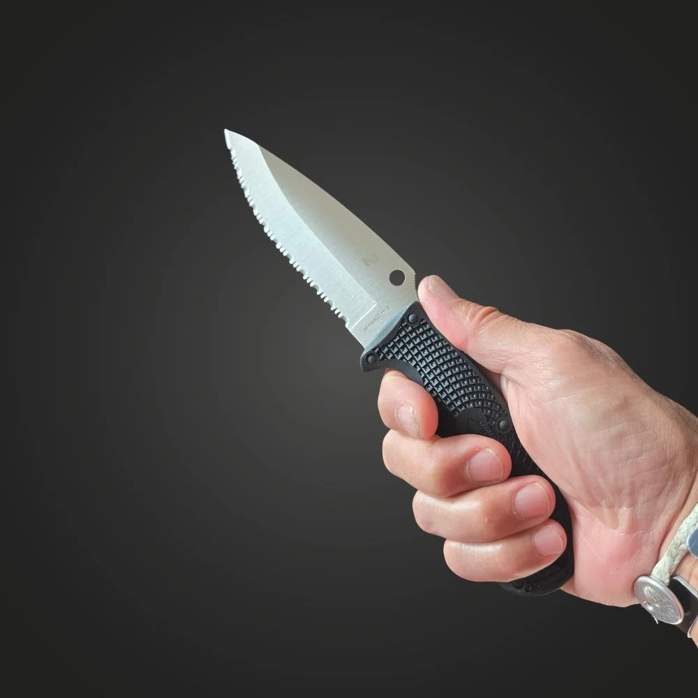 Spyderco Jumpmaster 2 held in a full grip, showing the textured FRN handle