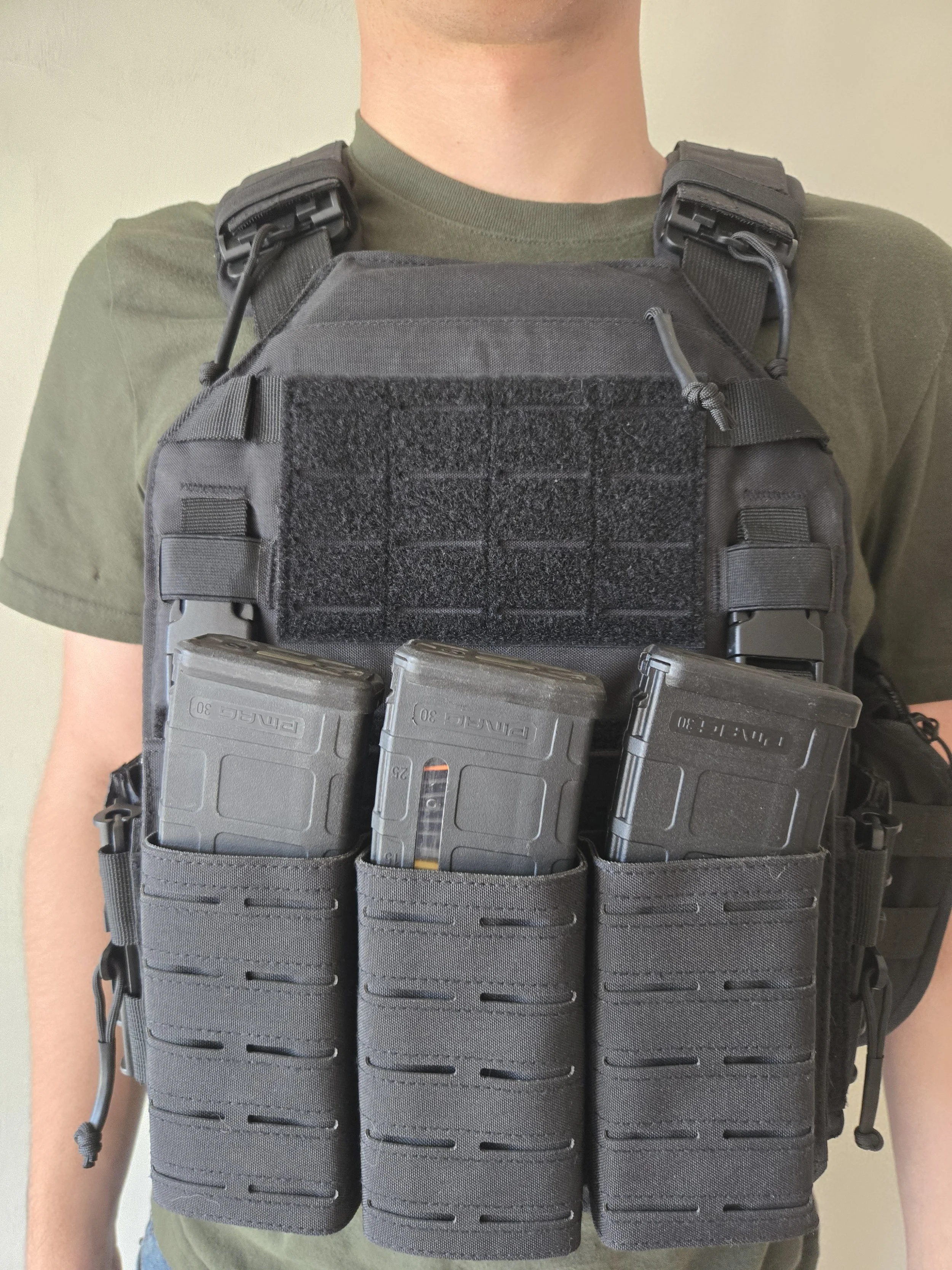 Black plate carrier loaded with PMAGs in triple mag pouch
