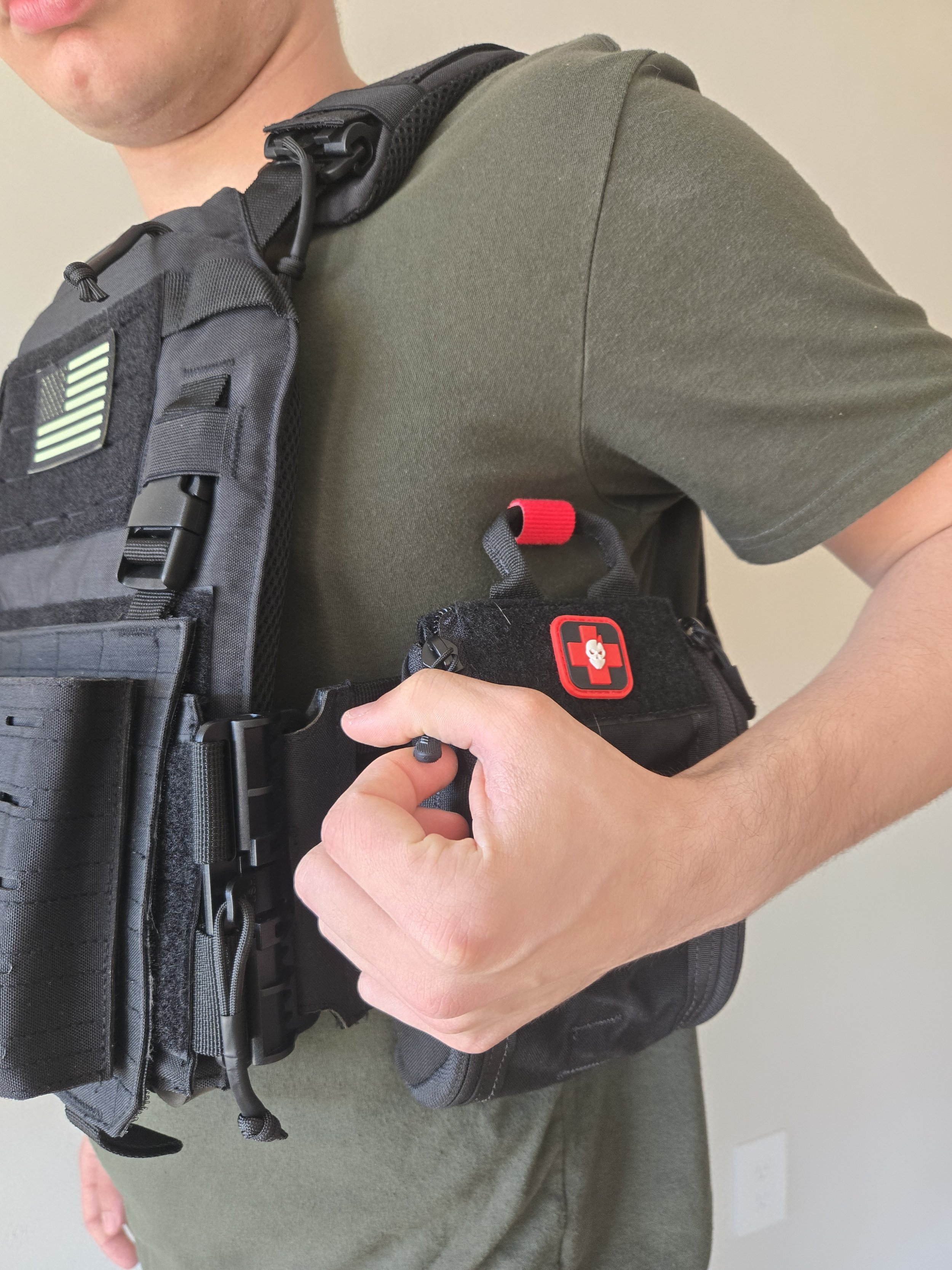 Plate carrier with IFAK pouch attached showing accessory compatibility