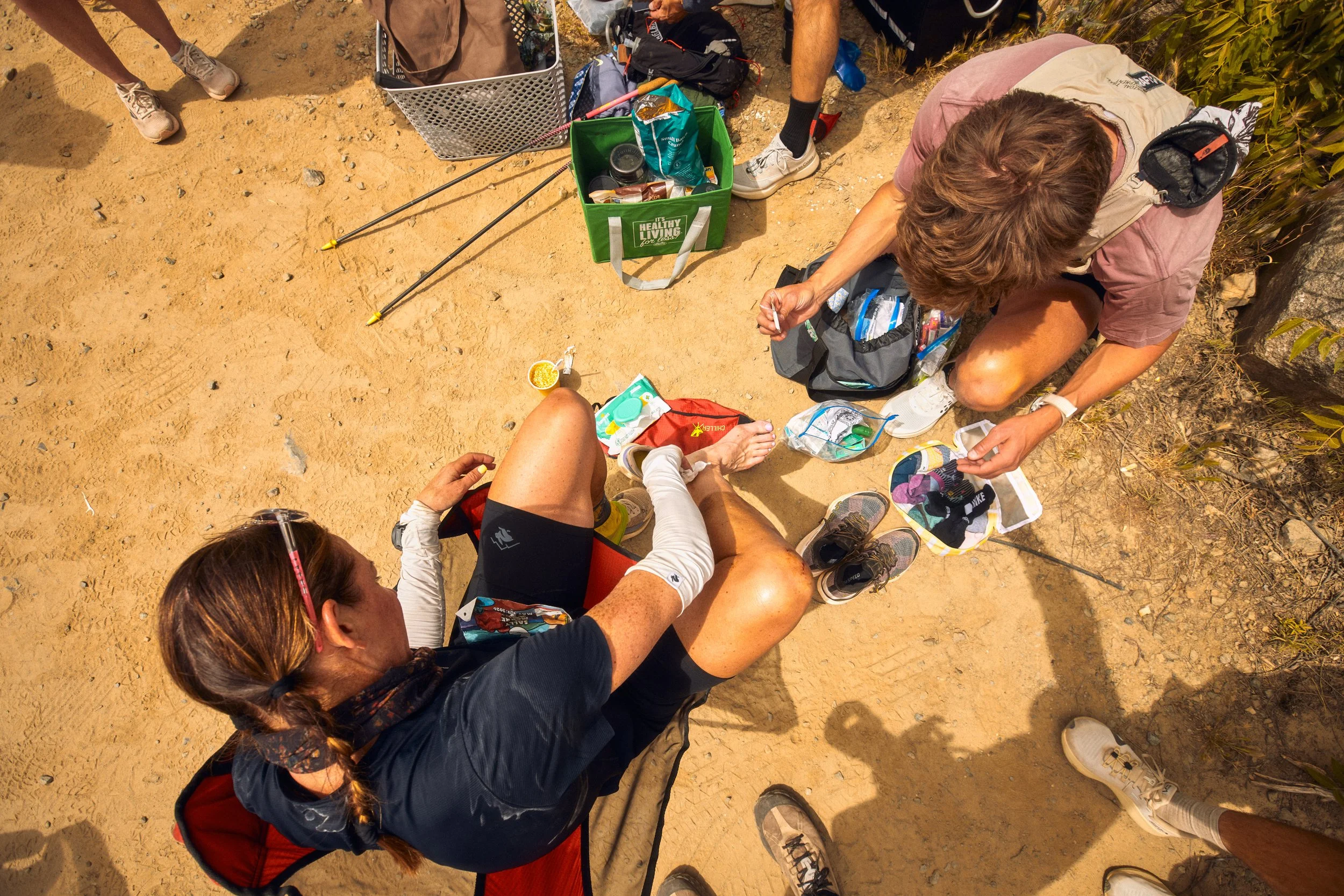 A group of people gathered at an aid station at Cocodona 250 