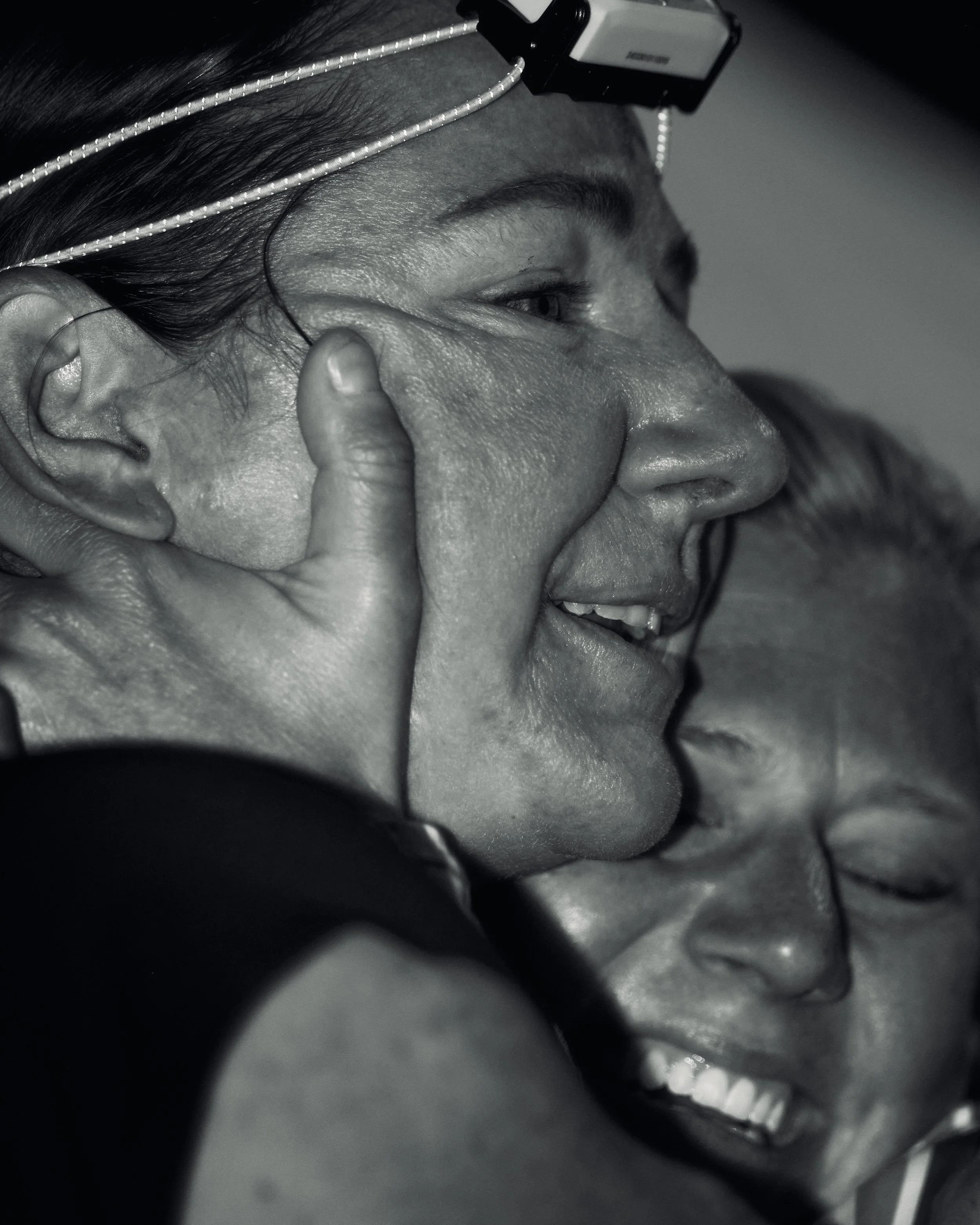 Close-up black and white photograph of a woman smiling 