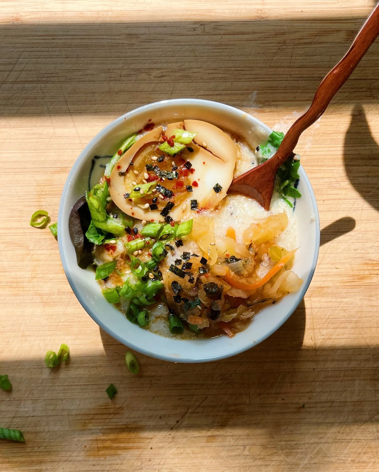 Taking a sick day, and craving just this &mdash; quinoa &amp; cream of wheat porridge topped with a soy marinated egg, kimchi, scallions, and furikake 🍲