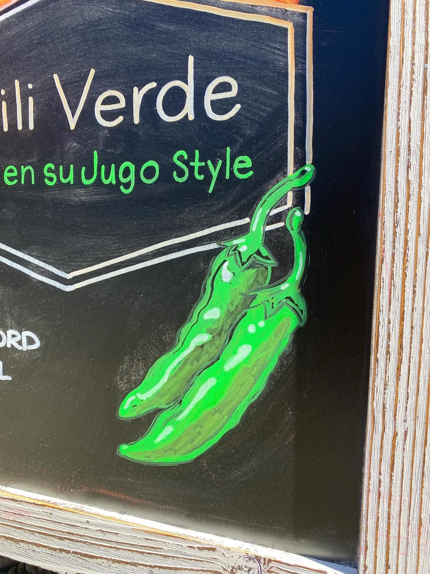 Closeup photo of hand illustrated roasted green peppers done on a chalkboard