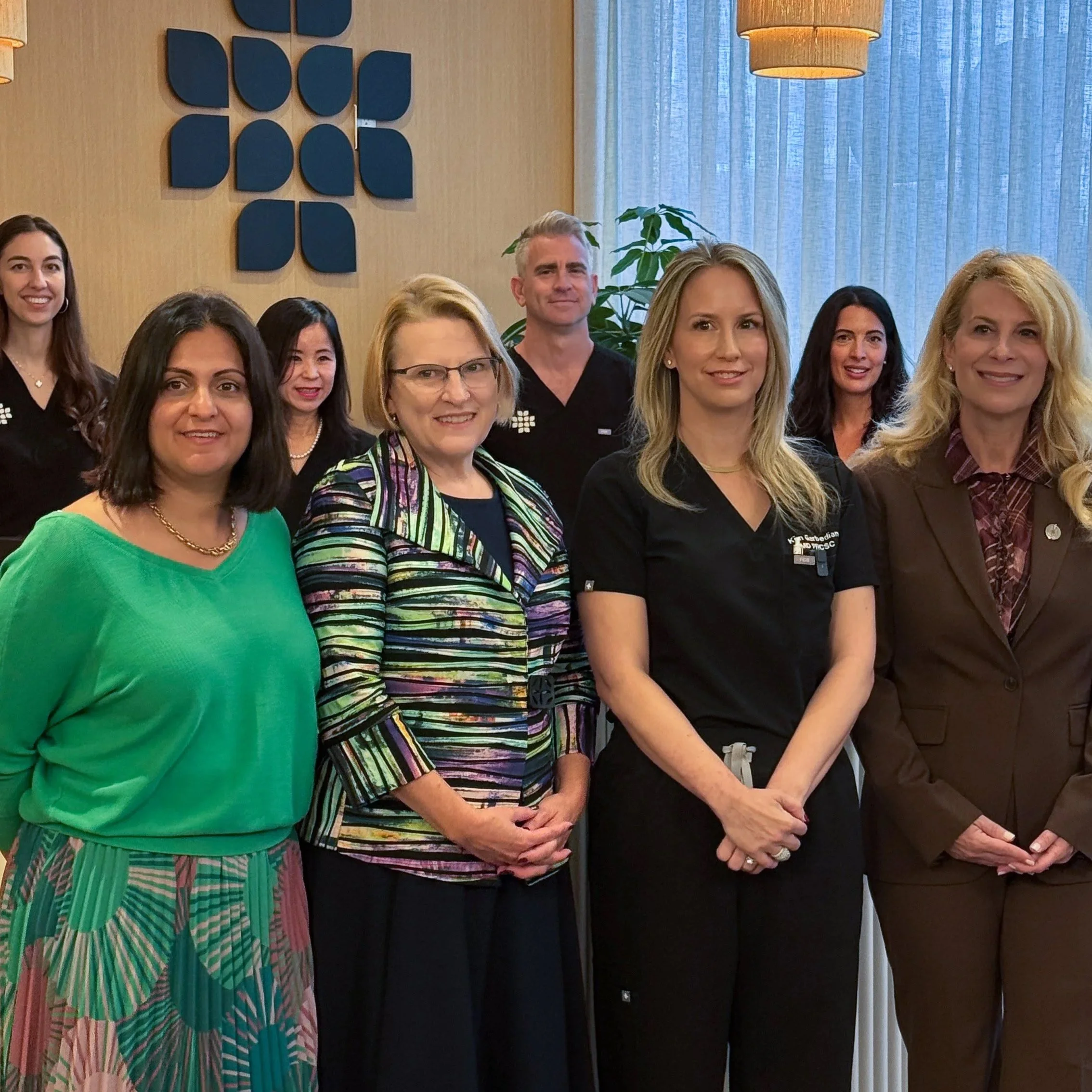 Group photo with a fertility doctor client and others at a company event.