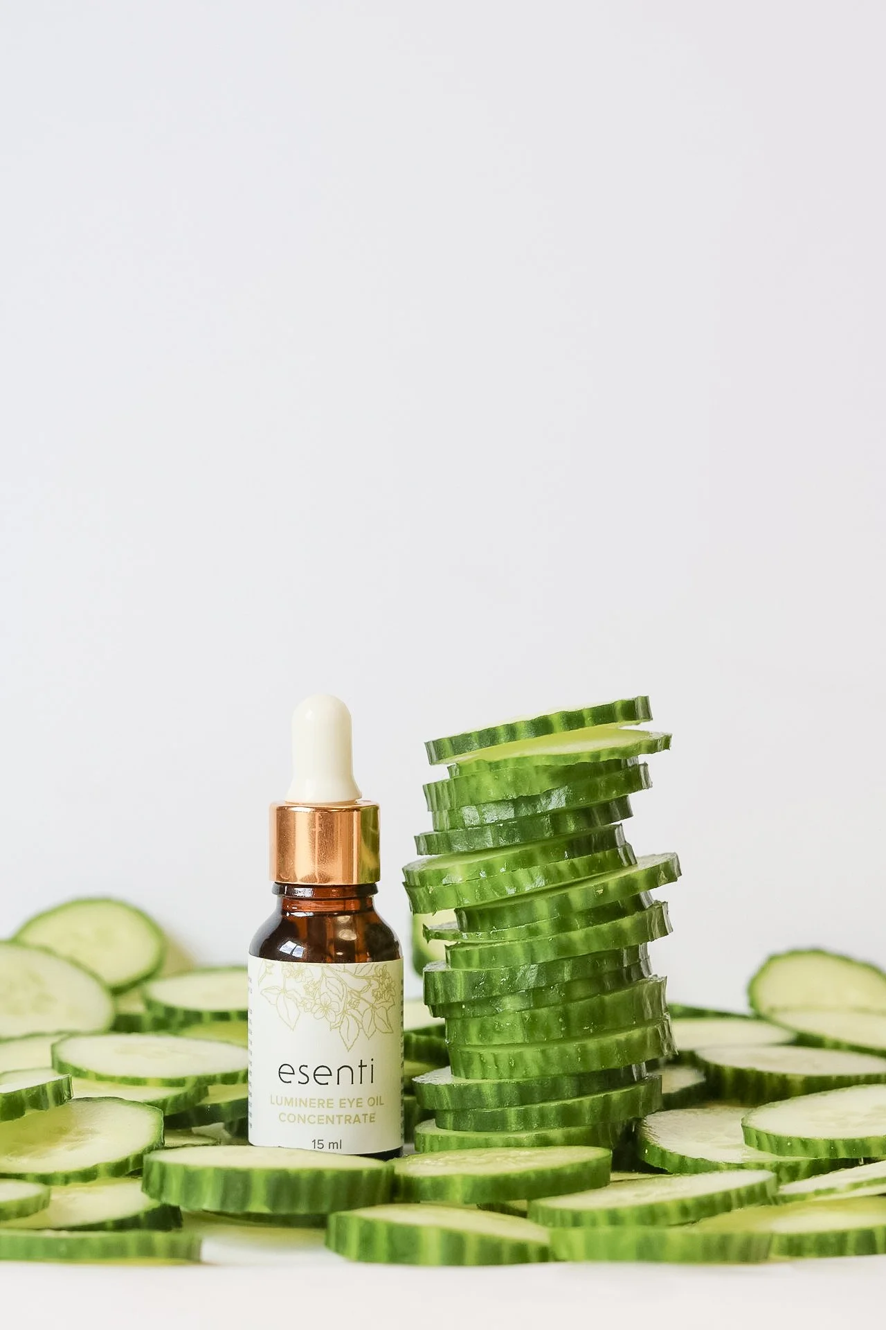 Eye oil concentrate styled with cucumber slices for a skincare client.