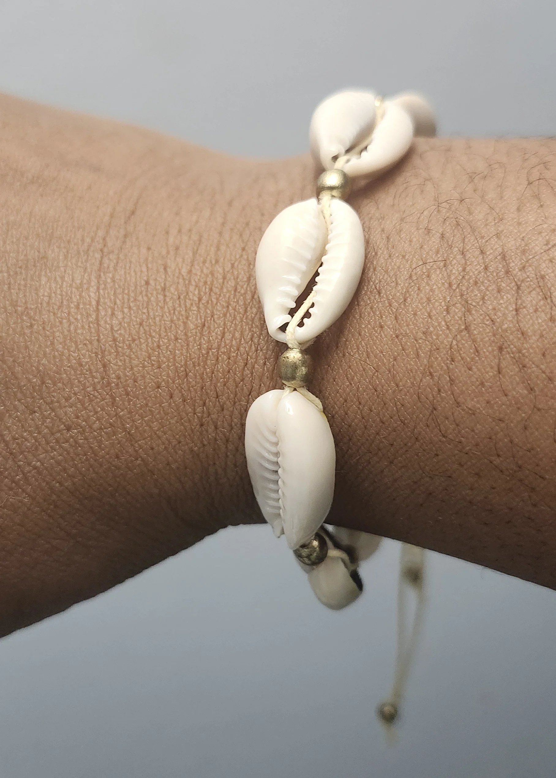 adjustable cowrie shell bracelet on wrist