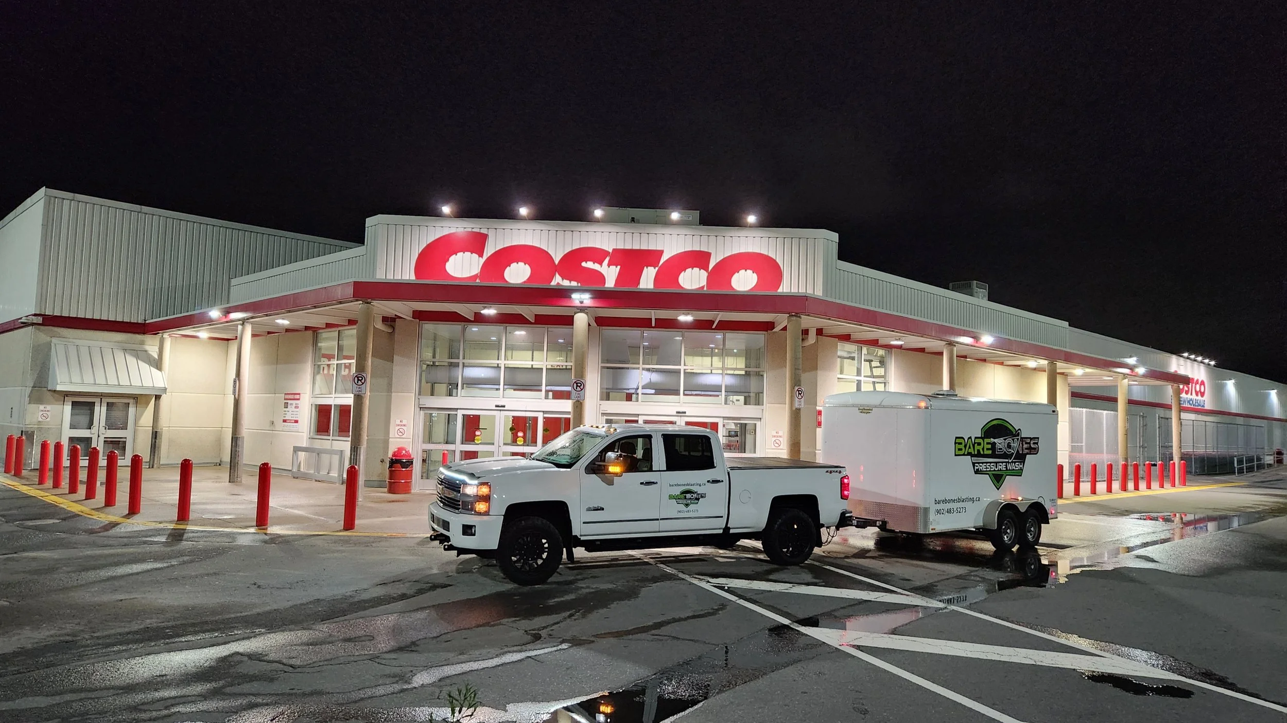 Bare Bones Truck and Trailer parking in front of Cotco at night, sidewalks freshly washed