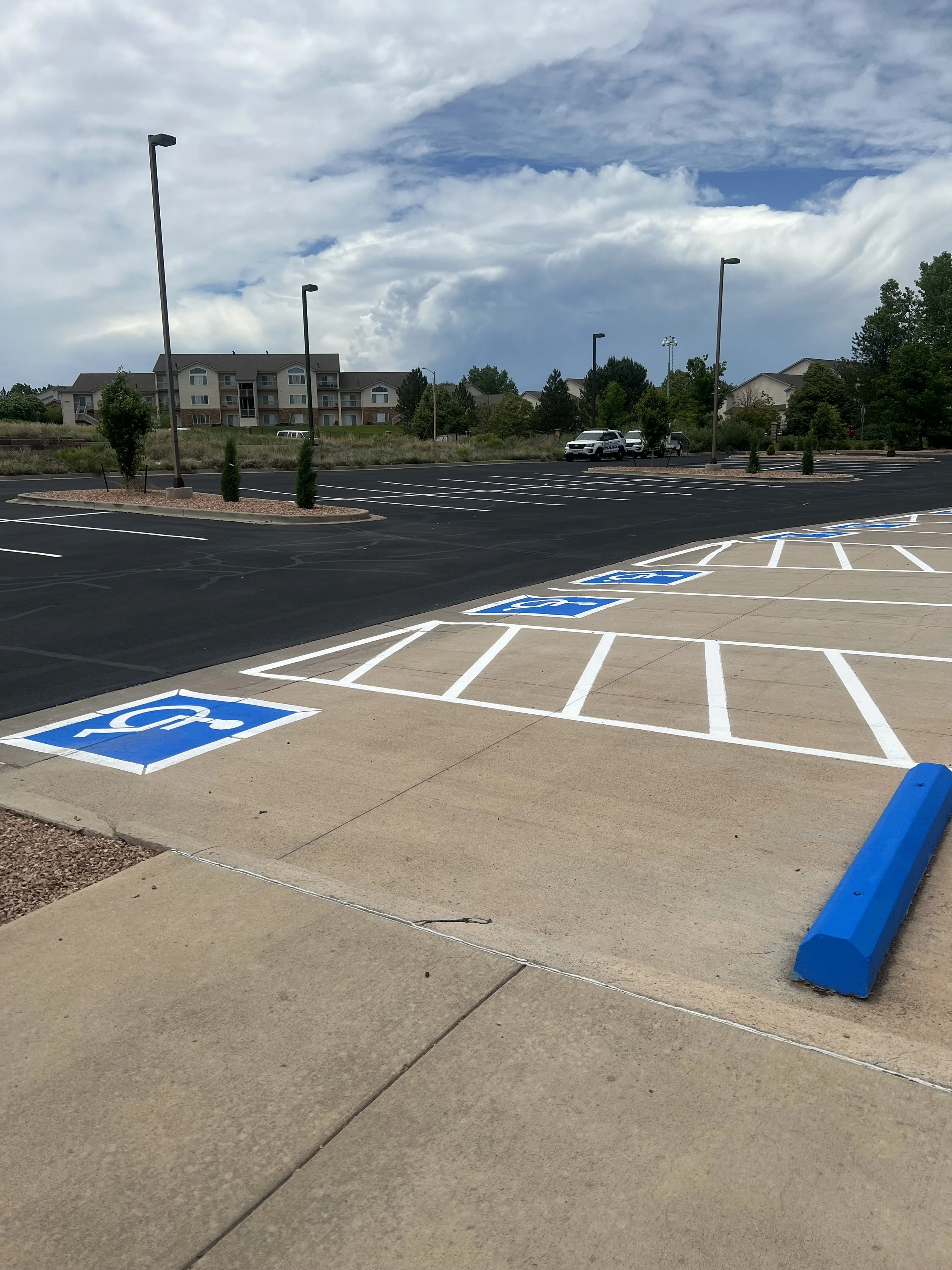 Asphalt sealcoat after asphalt sealing, crackseal and line striping in Pueblo