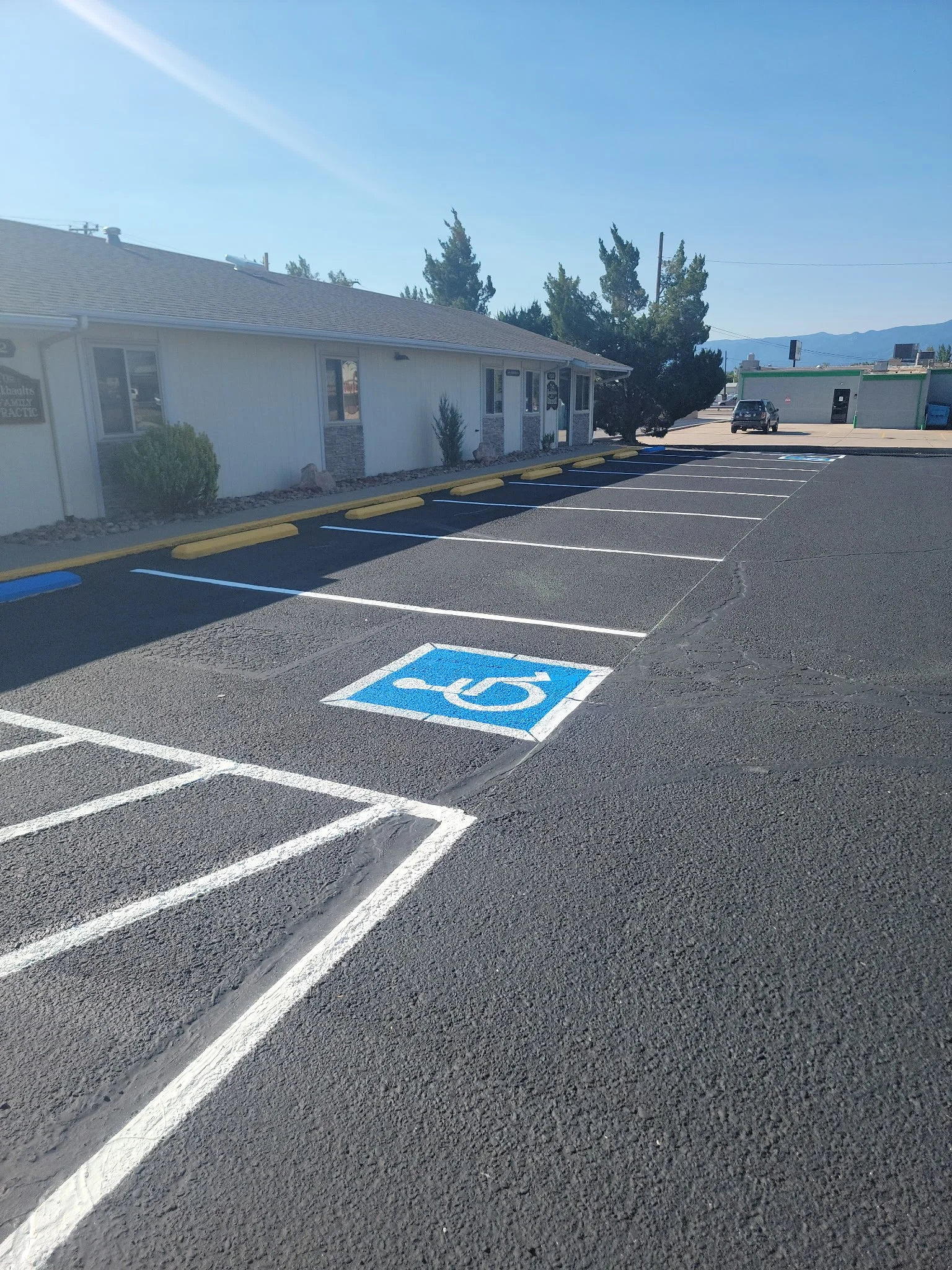 Commercial parking lot after sealcoat, crackseal and line striping in Cañon City