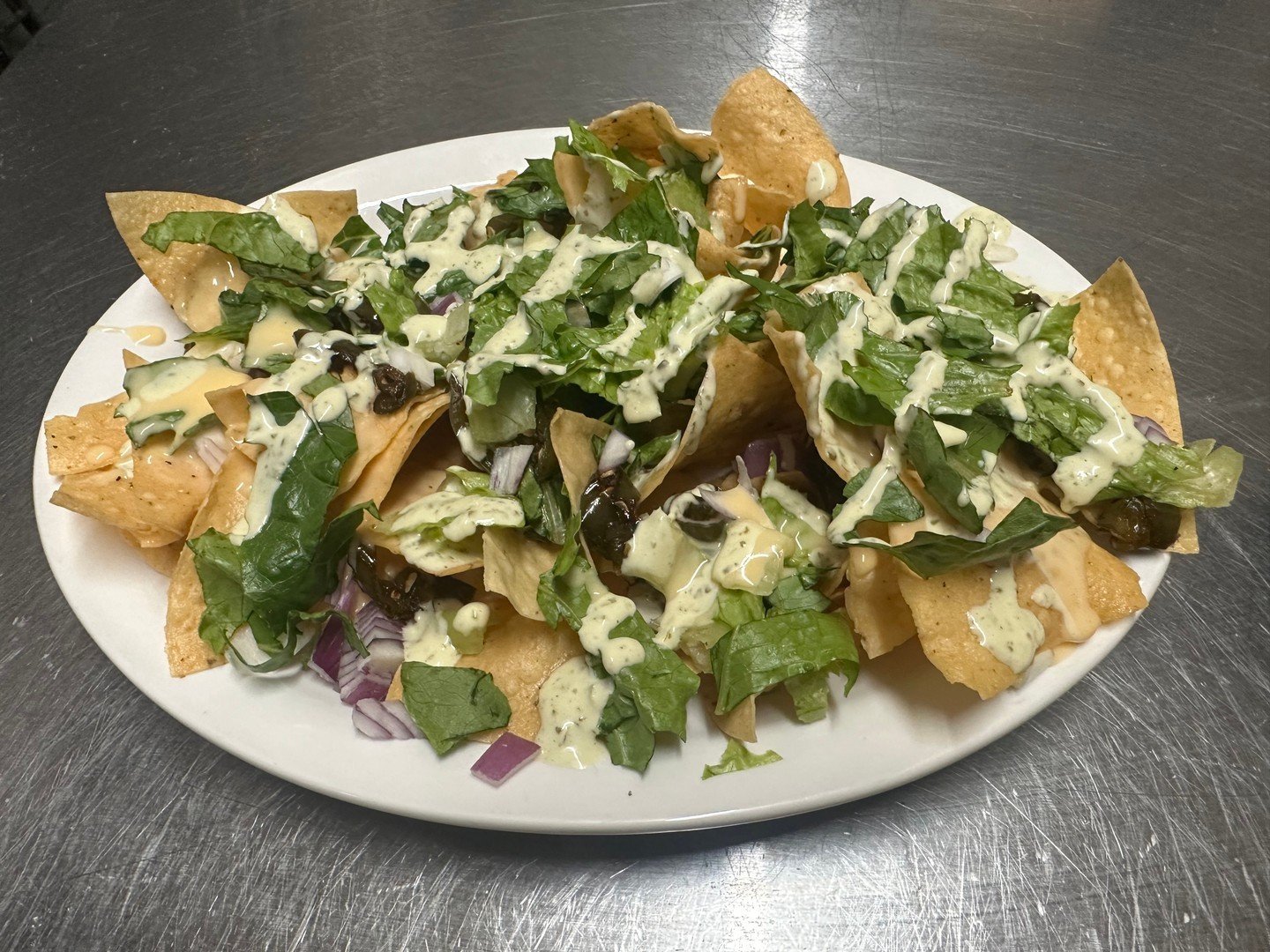 As an homage to your favorite TV chef - Guy Fieri - this is how we think we would describe our nachos - 🔥🌶️ Get ready to IGNITE your taste buds with St. Nick&rsquo;s EPIC Pub Nachos! Dive into a mountain of crunchy corn tortilla chips smothered in 