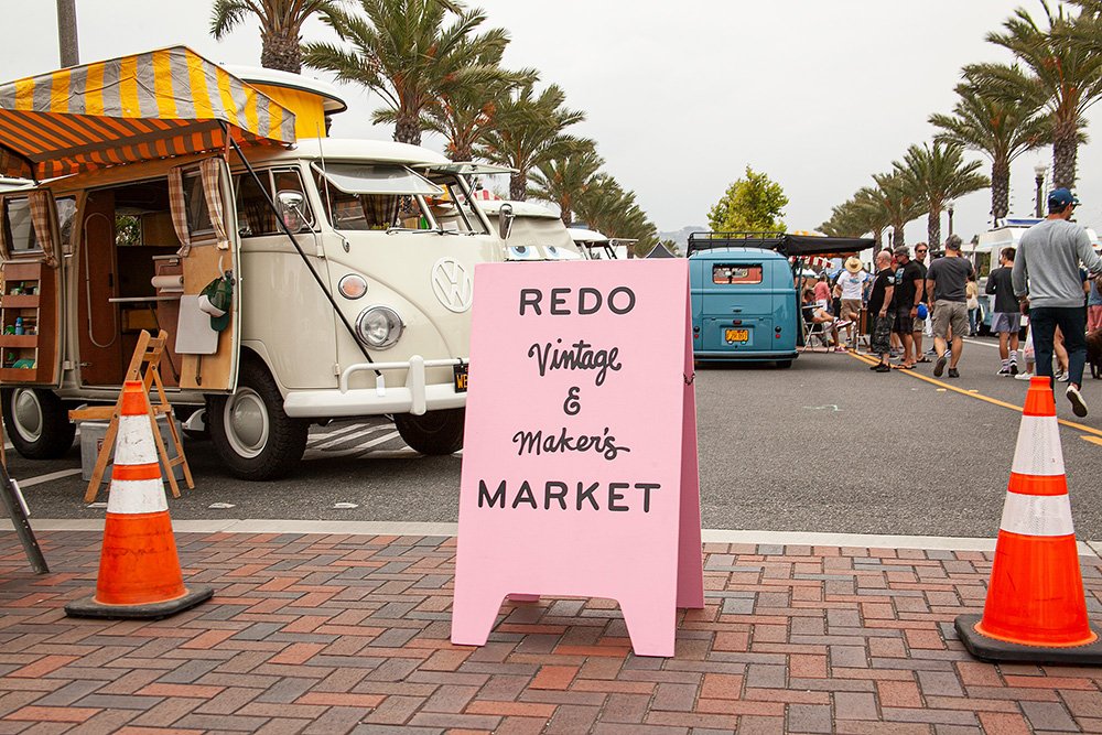 Outdoor vintage market with pink sign and VW van