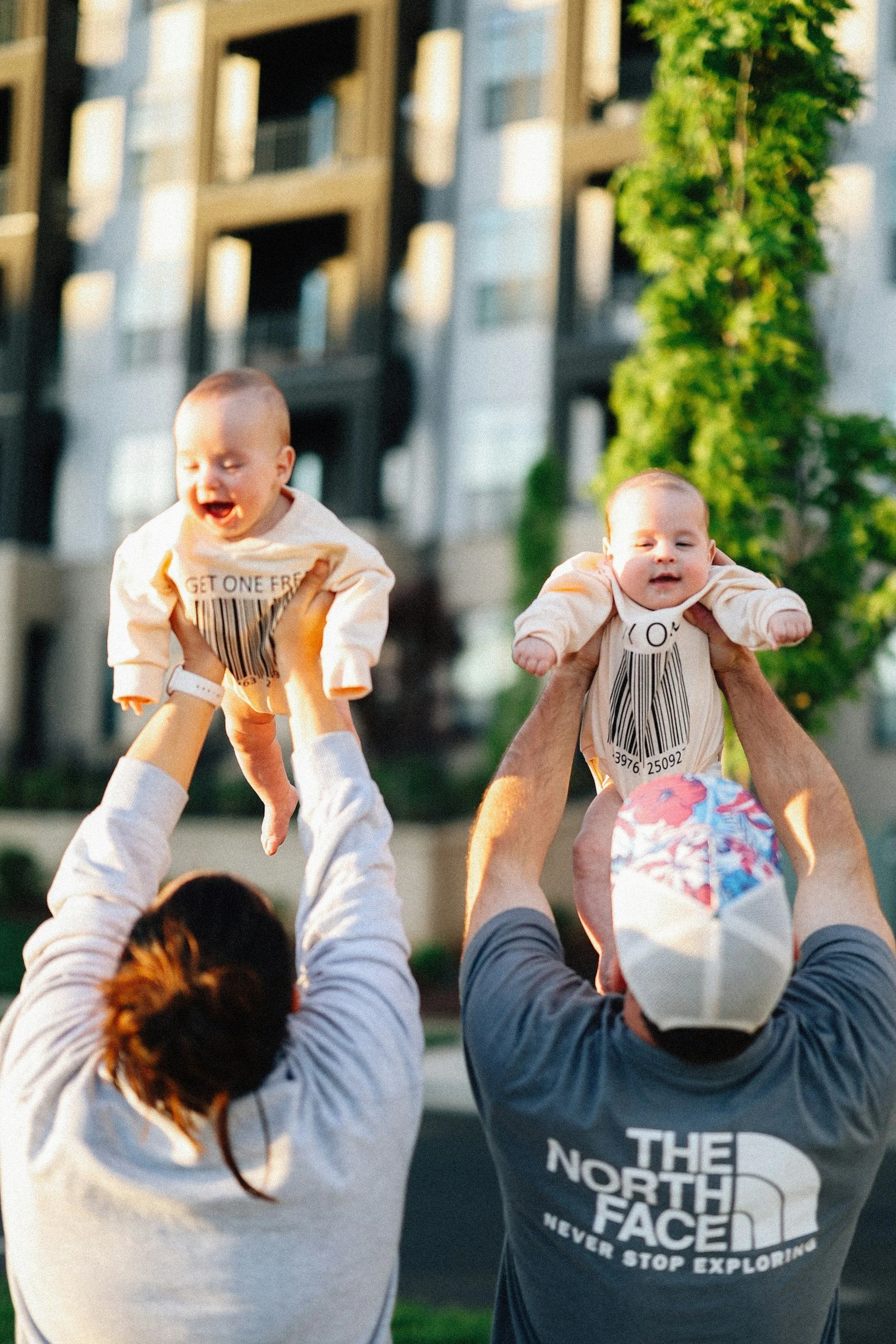 Image showing two parents each holding up a baby