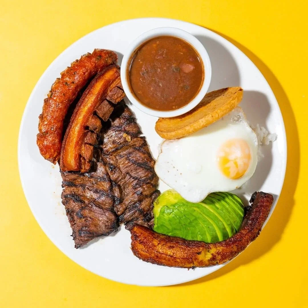 Colombian plate with steak, egg, plantain, sausage, avocado, beans, and arepa from Empanada Mama.