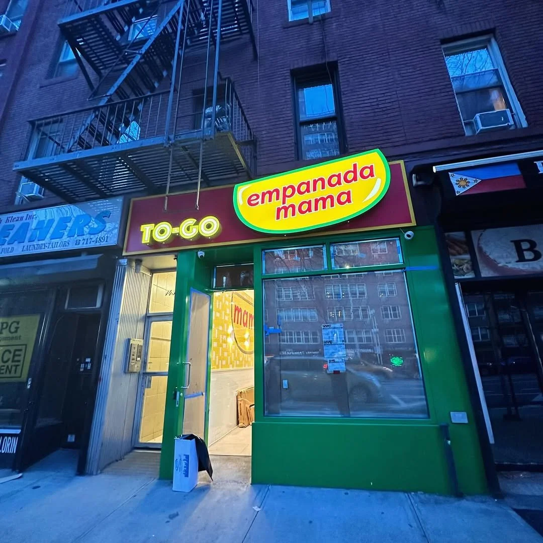 Empanada Mama TO-GO shop exterior on a busy New York street.