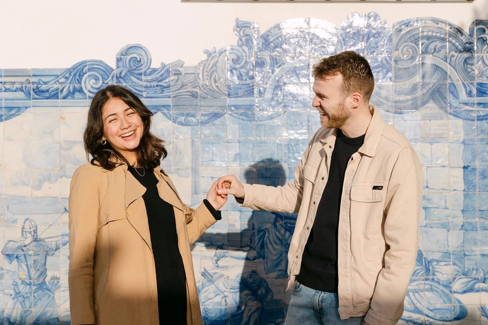 Couple photographed in front of traditional Portuguese azulejos in Lisbon