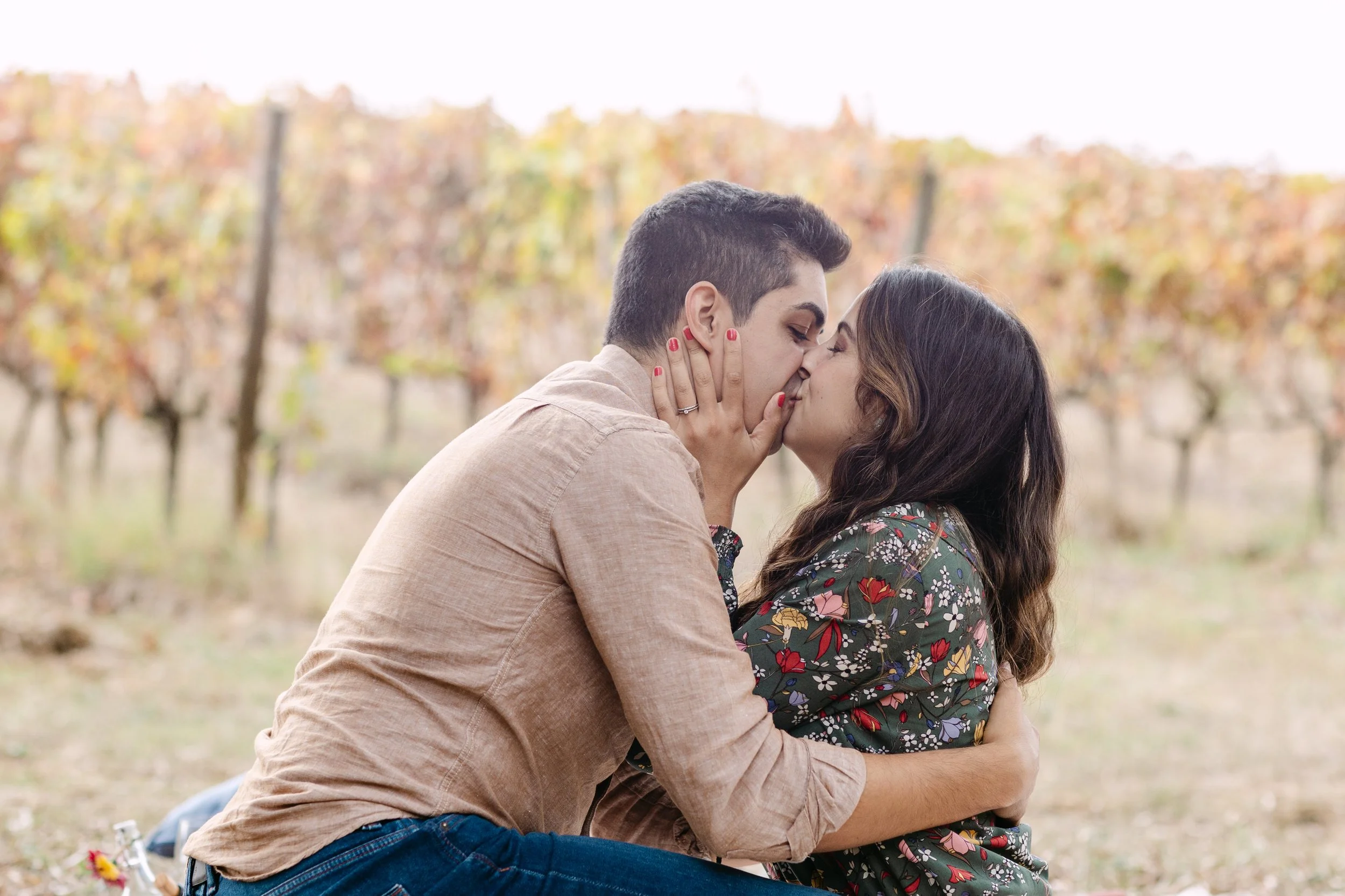 Couple kissing during romantic surprise proposal at Quinta de Santana vineyard