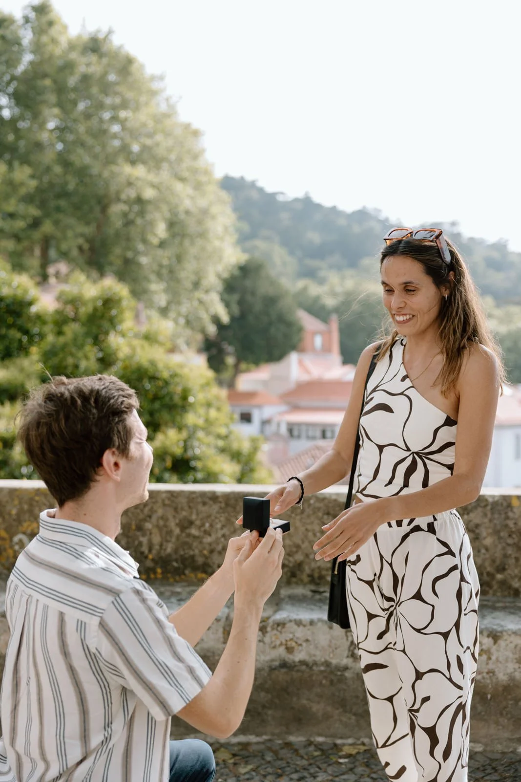 Emotional reaction moments after a surprise proposal in Sintra Village overlooking the forests of Sintra, Portugal.