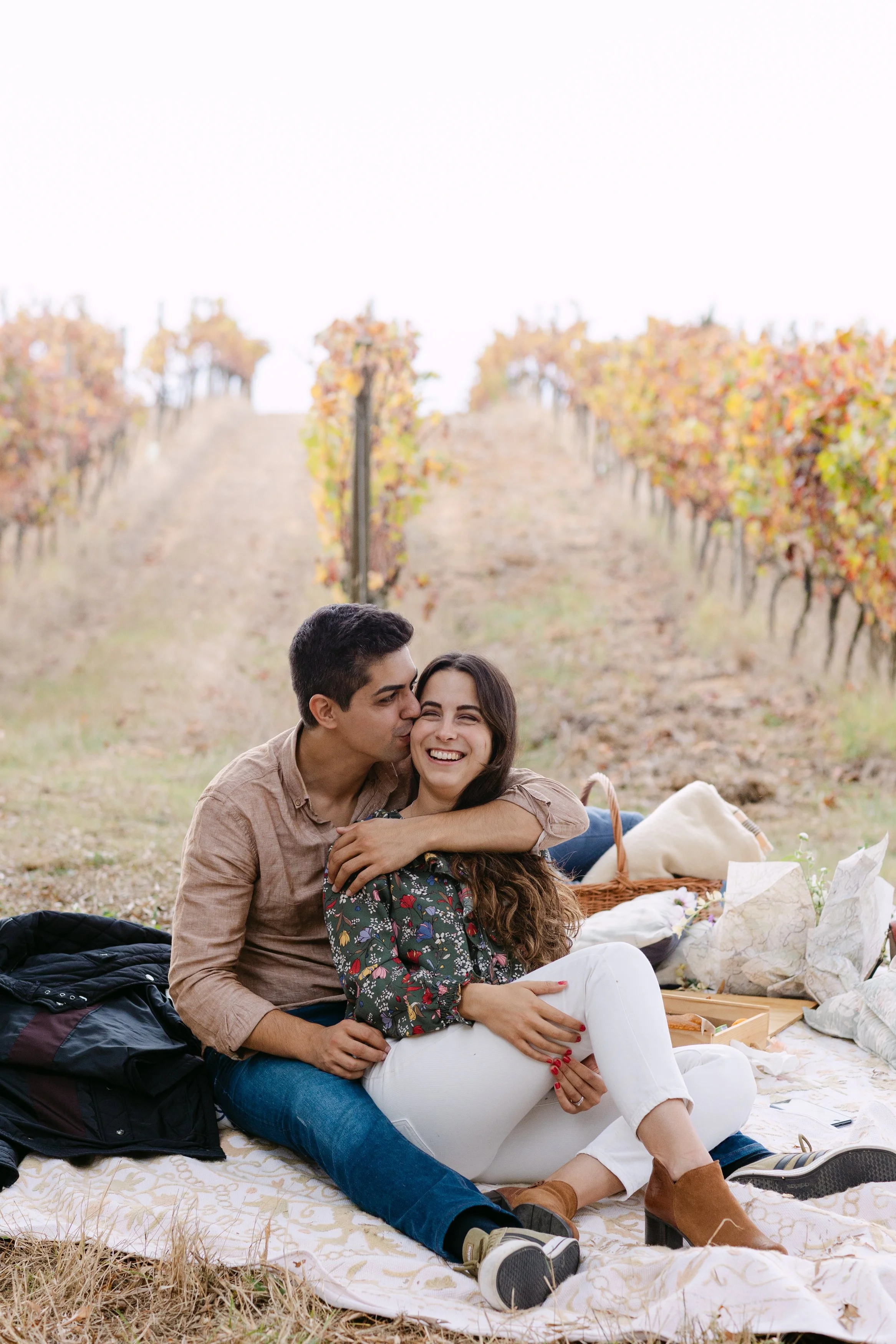 Recently engaged couple cuddling during Quinta de Santana vineyard proposal session