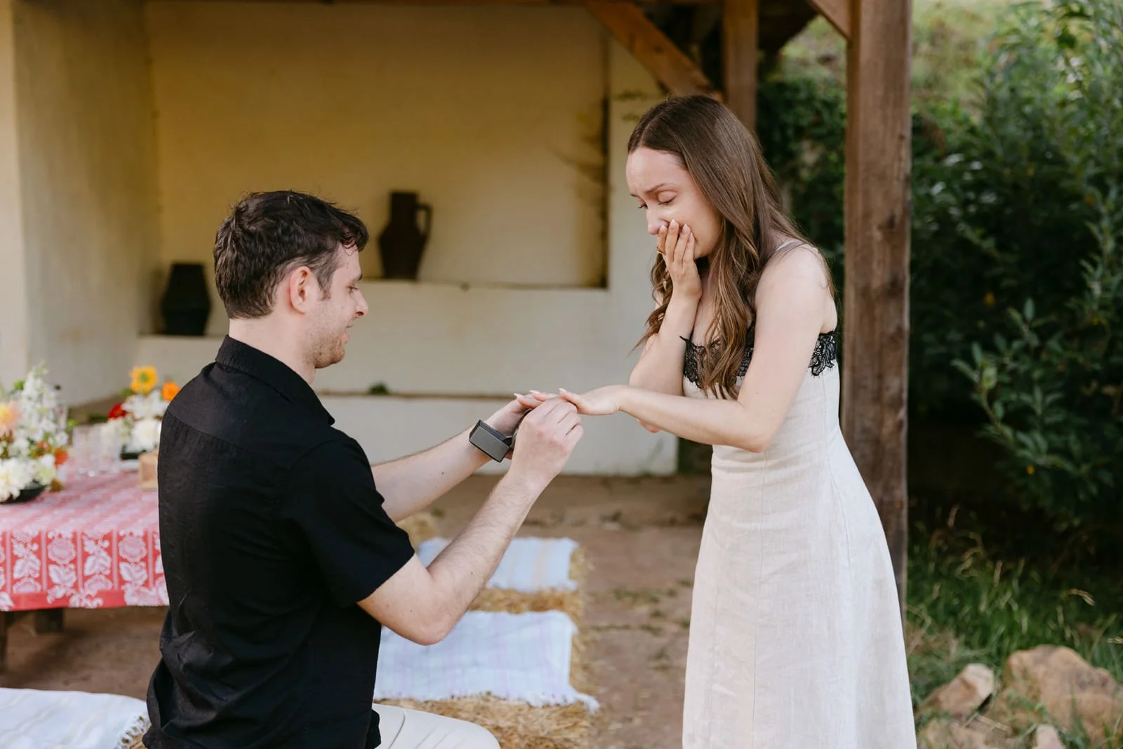 Emotional bride-to-be watching as her partner places the engagement ring on her finger during their Quinta de Sant’Ana proposal.