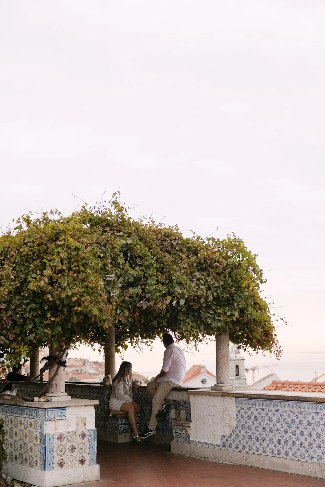 Couple enjoying the view at Miradouro de Santa Luzia moments before a surprise proposal in Lisbon