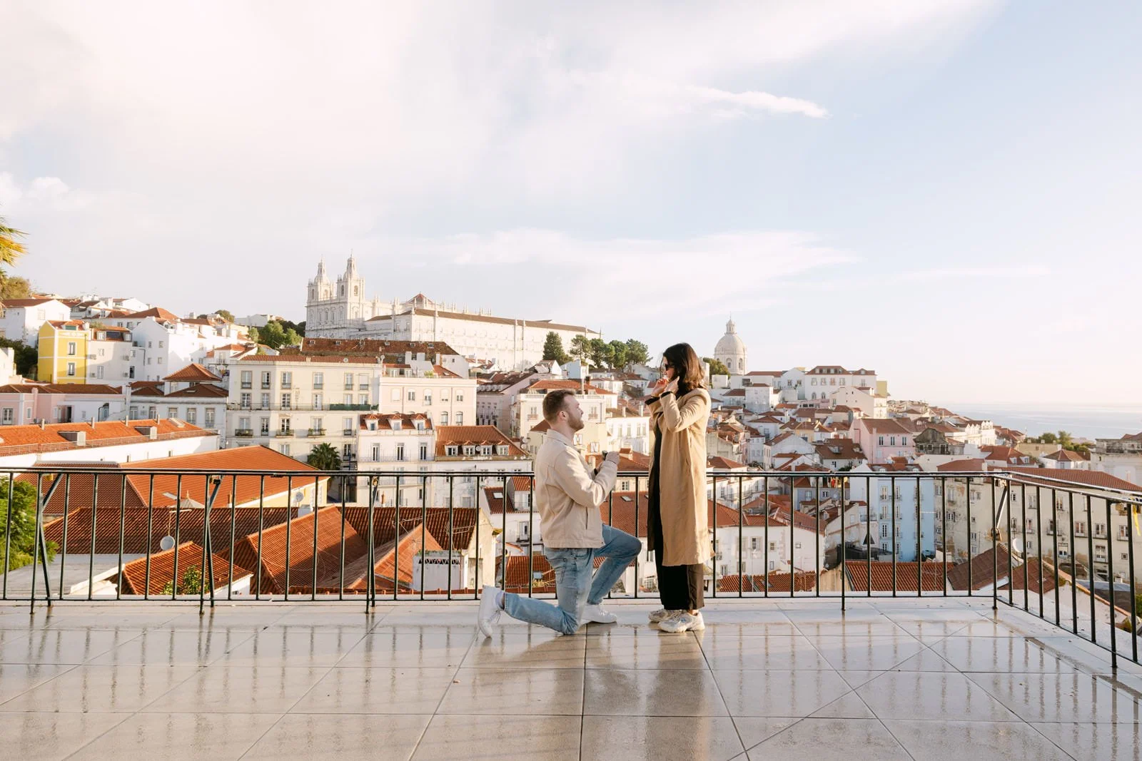 Surprise proposal at Miradouro das Portas do Sol overlooking Alfama and Lisbon rooftops