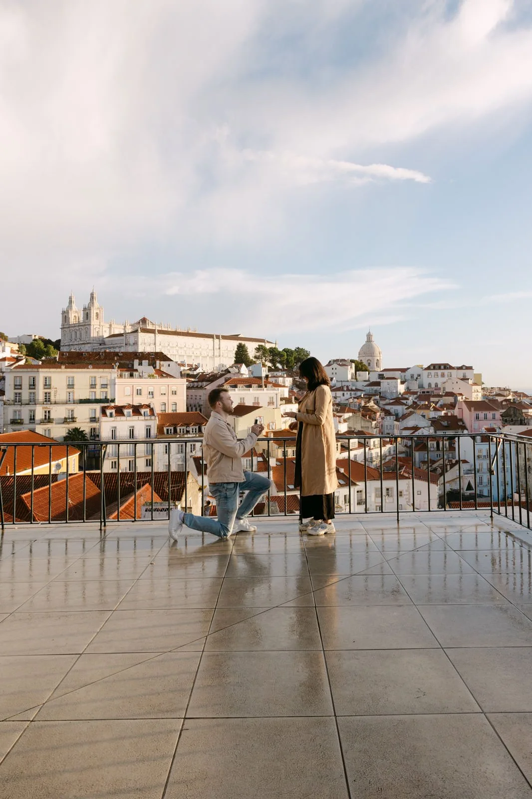 Man proposing at Miradouro das Portas do Sol during a surprise proposal in Lisbon