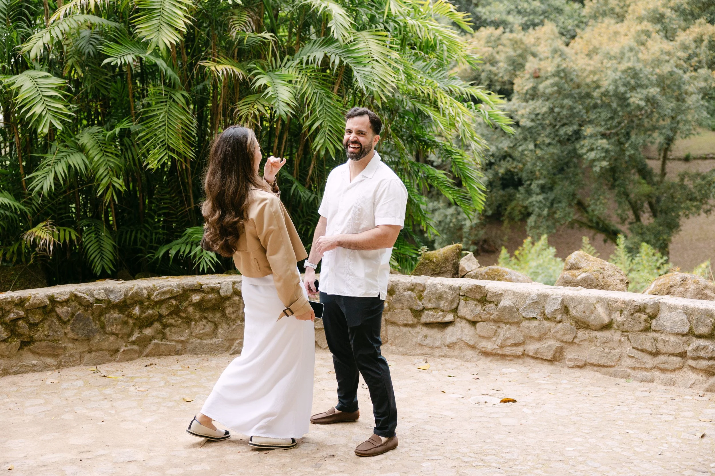 Couple celebrating their engagement at Monserrate ruins surrounded by lush greenery in Sintra.