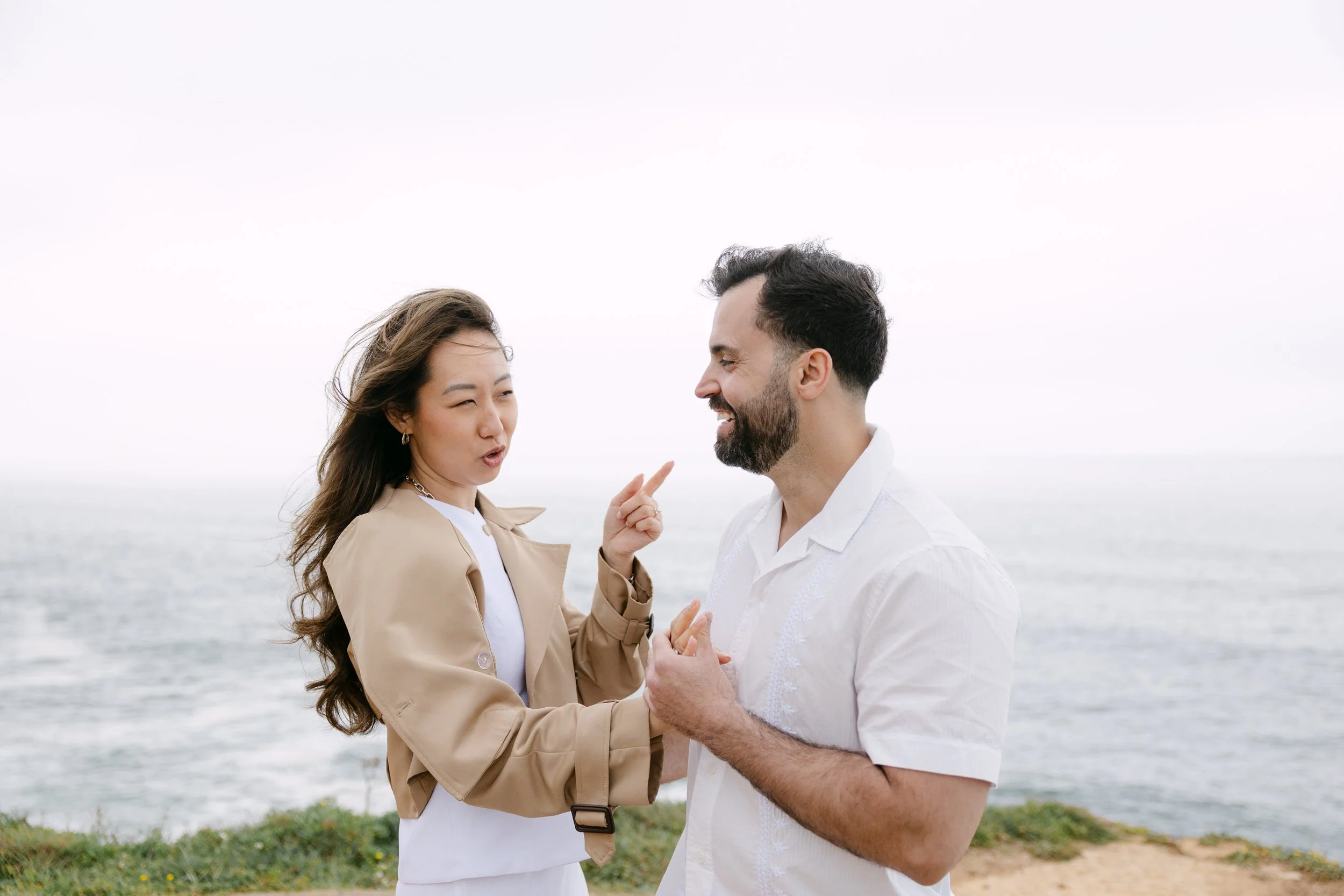 Fun portrait of engaged couple with coastal views in Azenhas do Mar during engagement session.