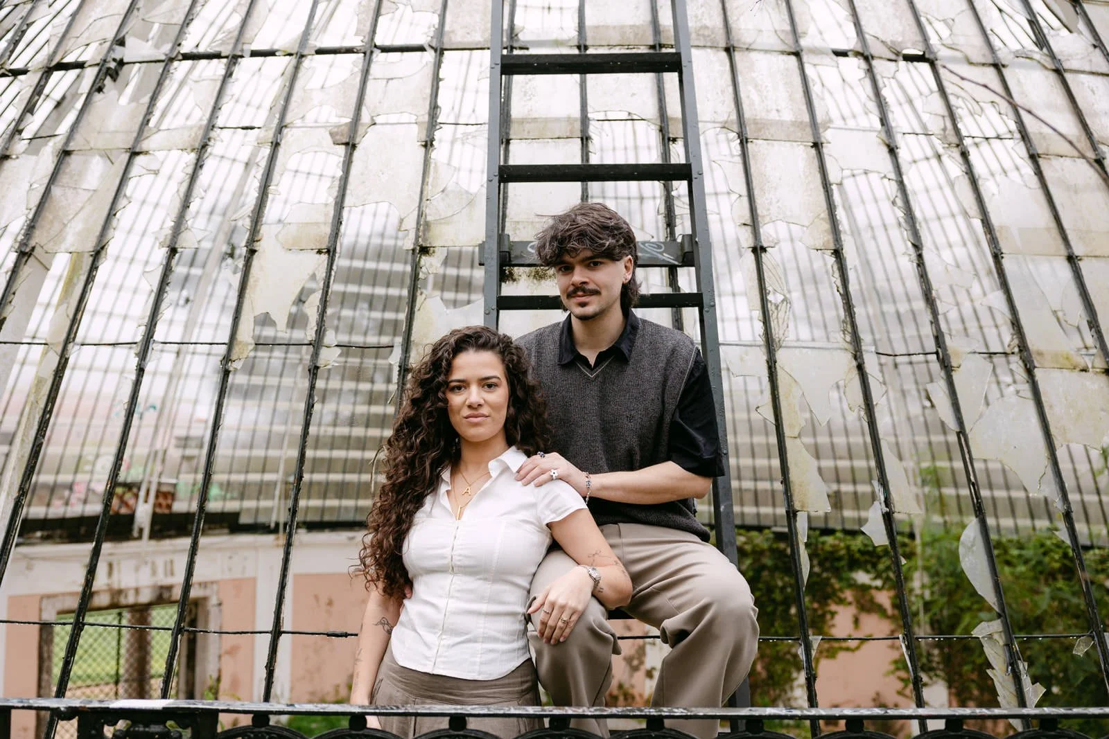 Editorial portrait of an engaged couple in front of the historic greenhouse at Tapada das Necessidades