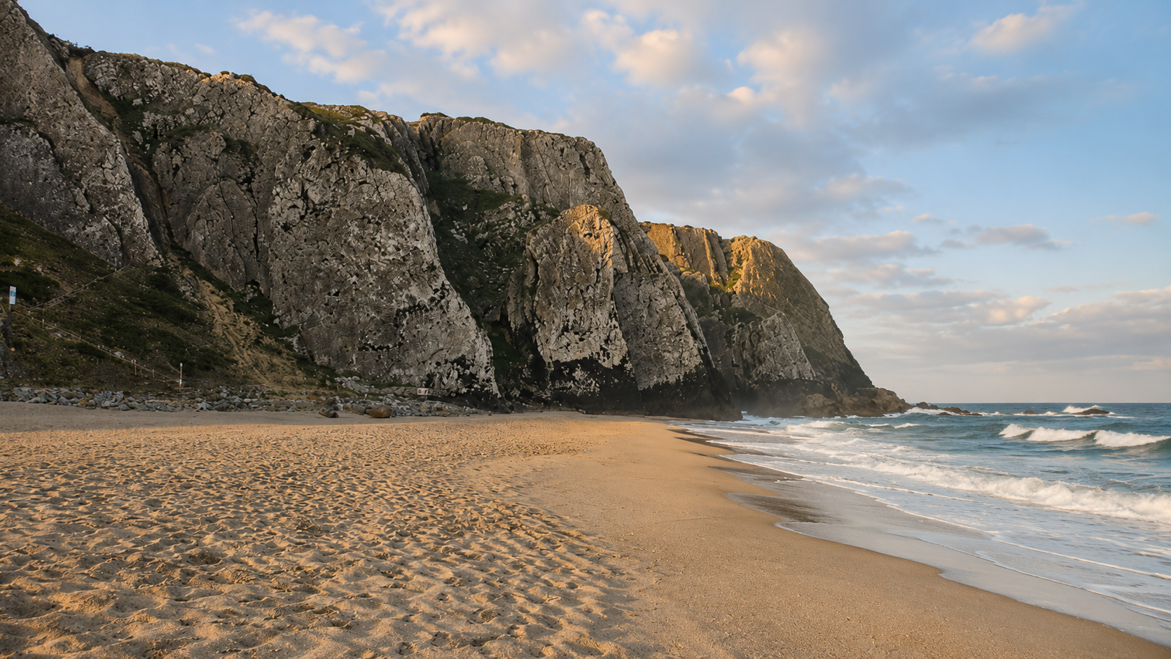 Praia Grande in Sintra featuring wide sandy beaches, dramatic cliffs and Atlantic Ocean views, perfect for relaxed and natural couple photography.