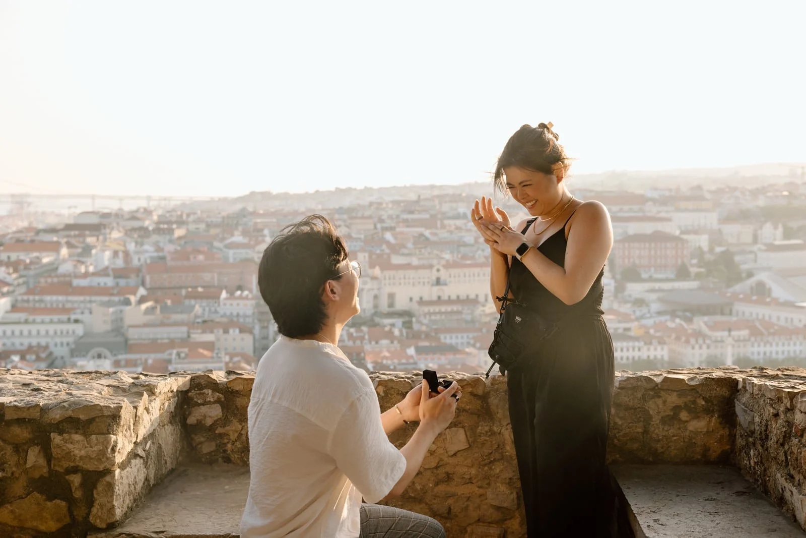 Emotional reaction moments after a surprise proposal at Castelo de São Jorge in Lisbon.