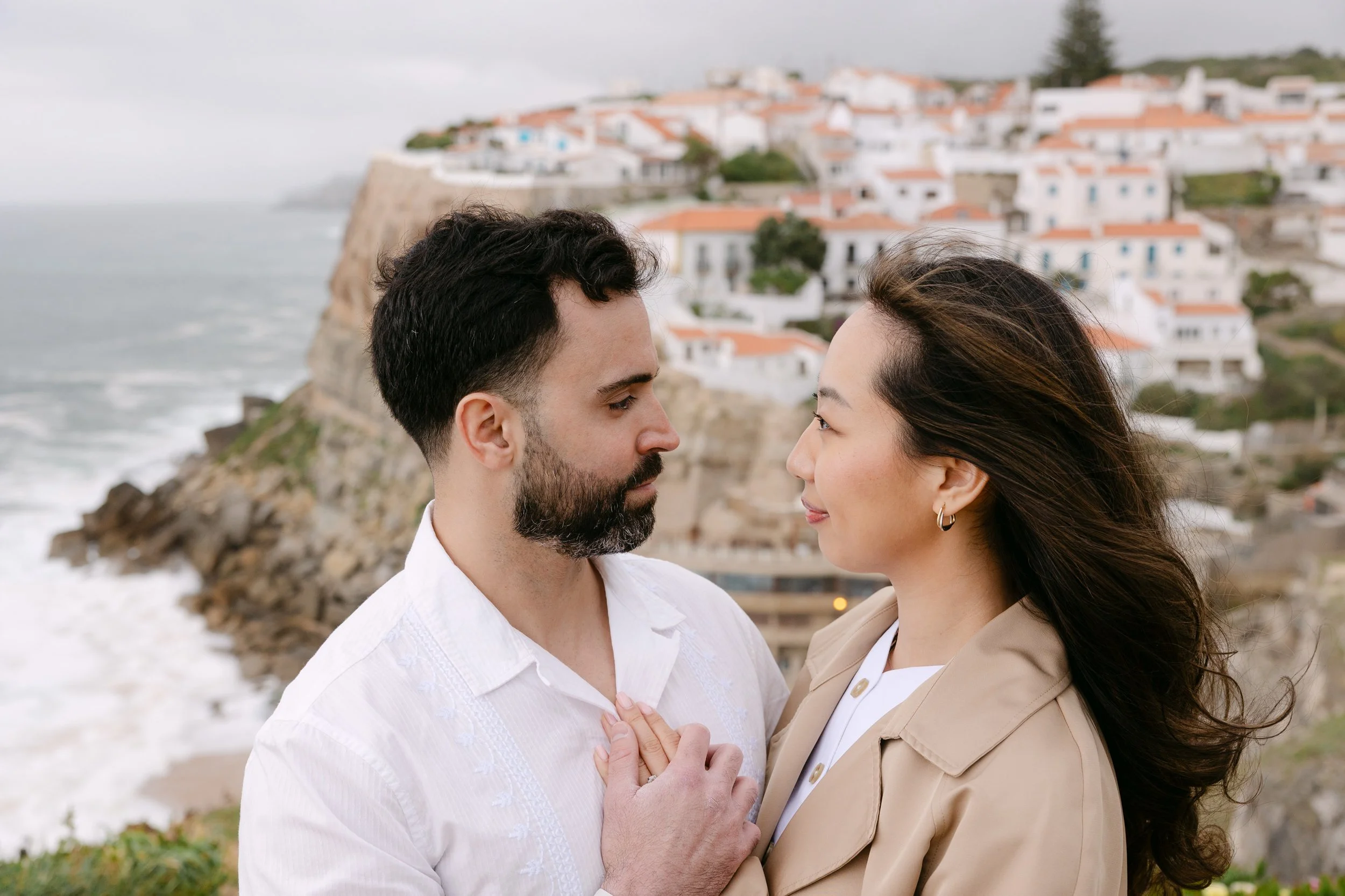Romantic portrait of engaged couple with dramatic cliffs and ocean views in Azenhas do Mar.