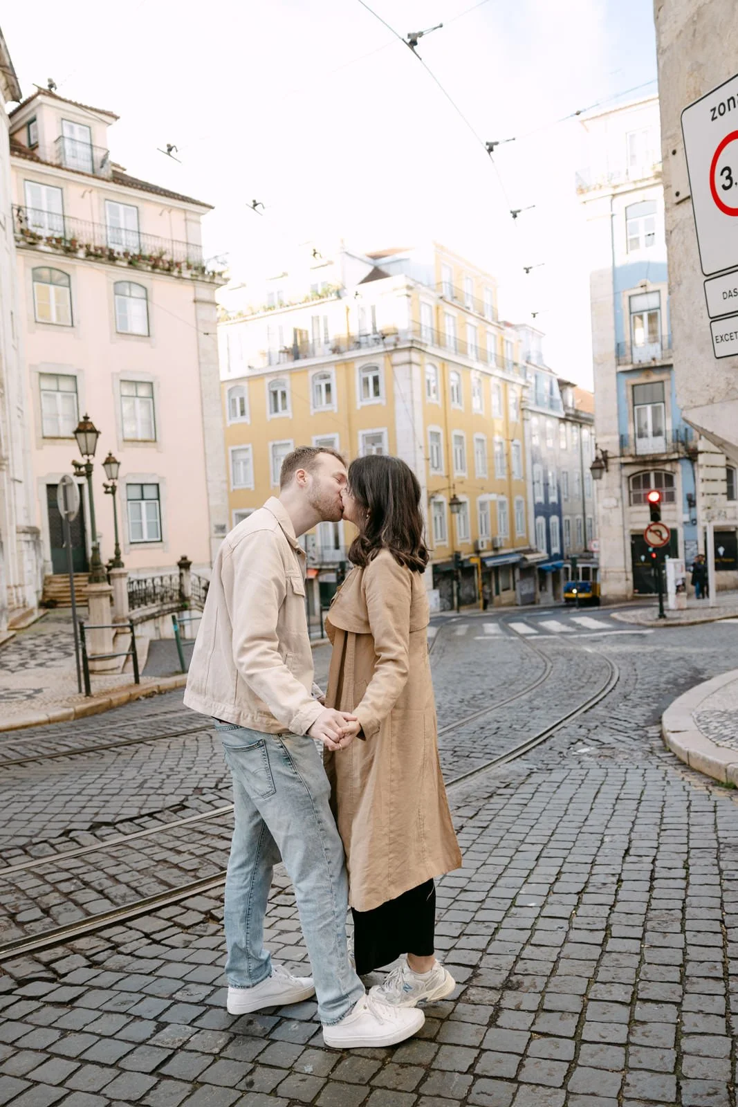 Couple kissing in Alfama after a surprise proposal in Lisbon