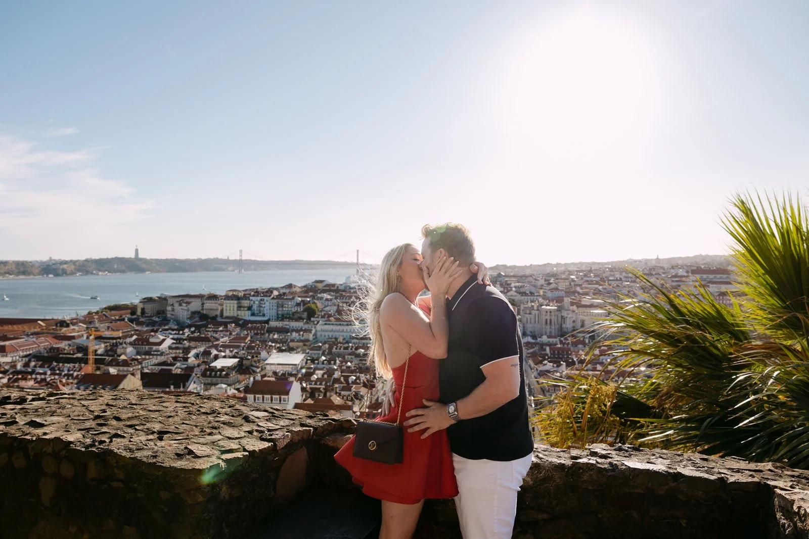 Recently engaged couple overlooking Lisbon after a proposal at Castelo de São Jorge