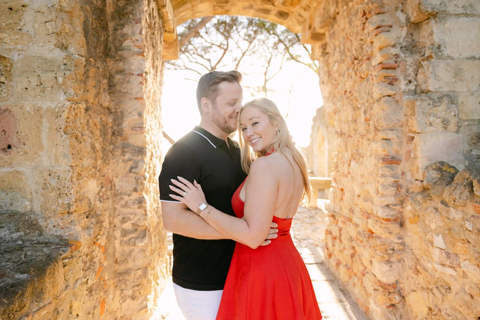 Recently engaged couple photographed at Castelo de São Jorge in Lisbon after a surprise proposal