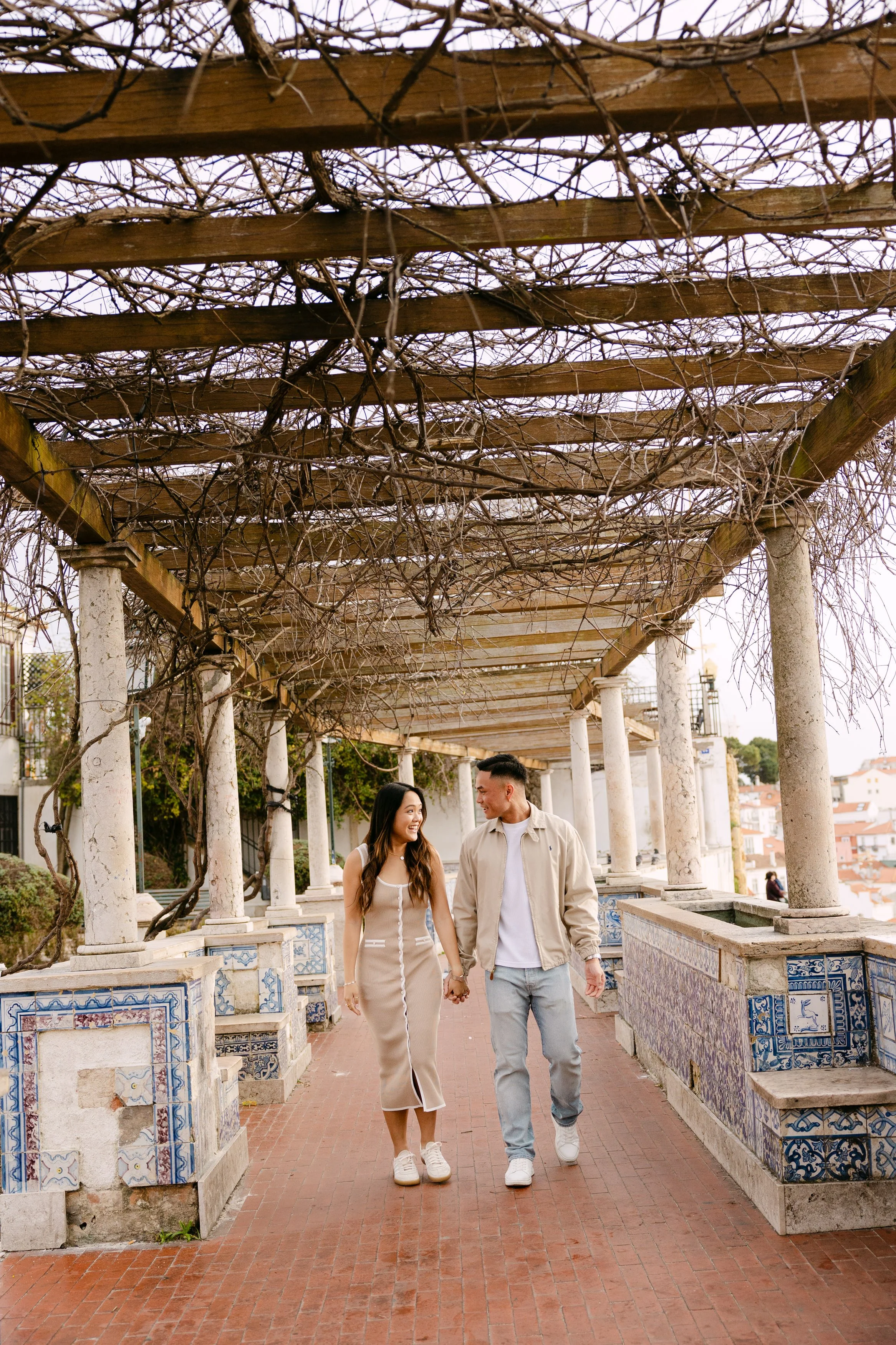 Couple walking through Santa Luzia during romantic engagement session in Lisbon