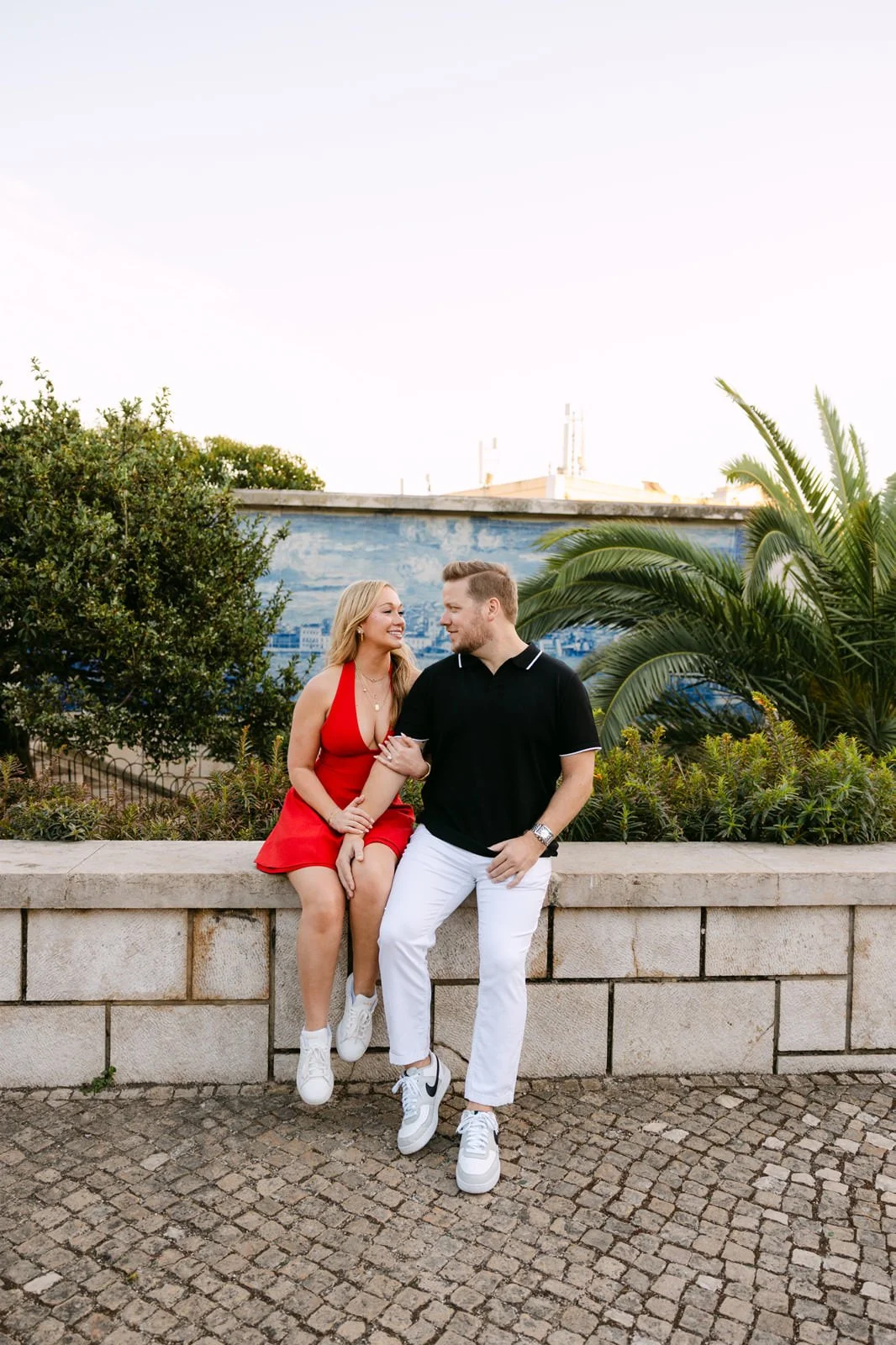 Couple celebrating their engagement with Lisbon views at Castelo de São Jorge