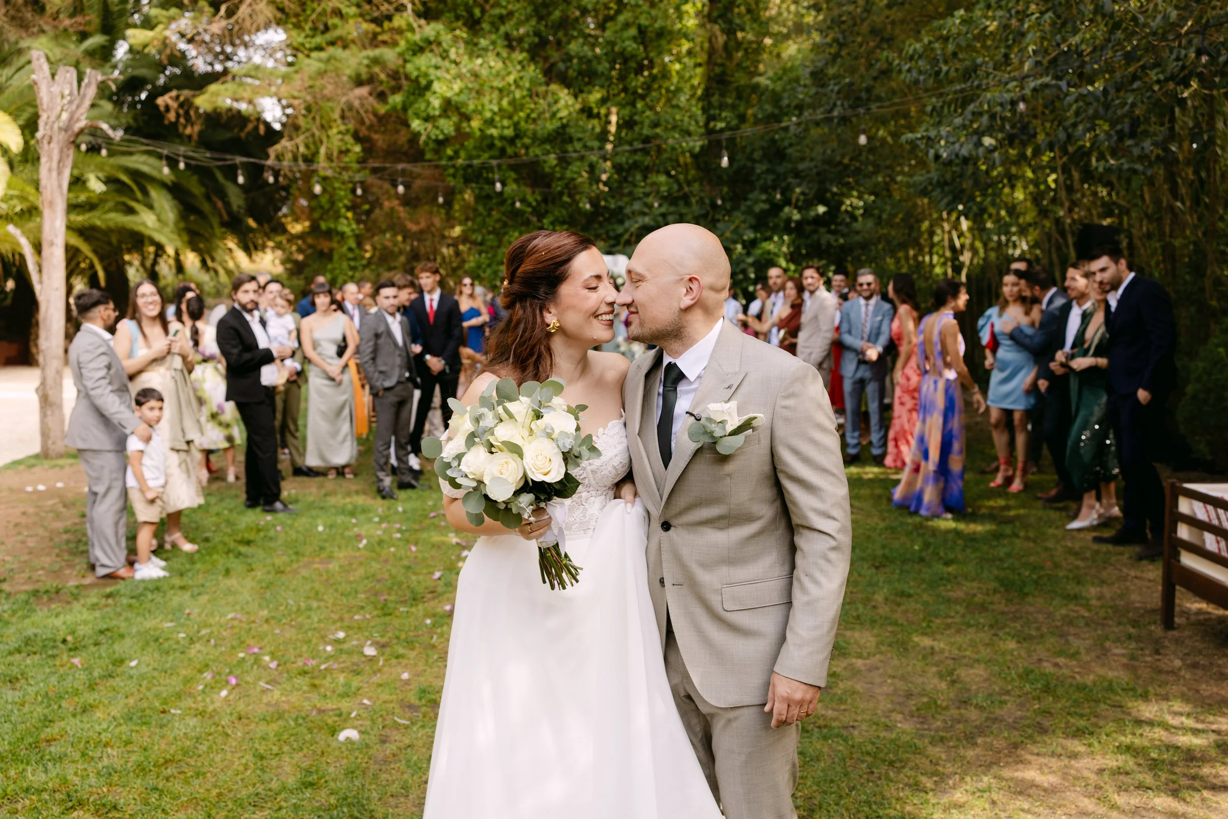 Outdoor wedding ceremony kiss surrounded by guests, documentary wedding photography Portugal