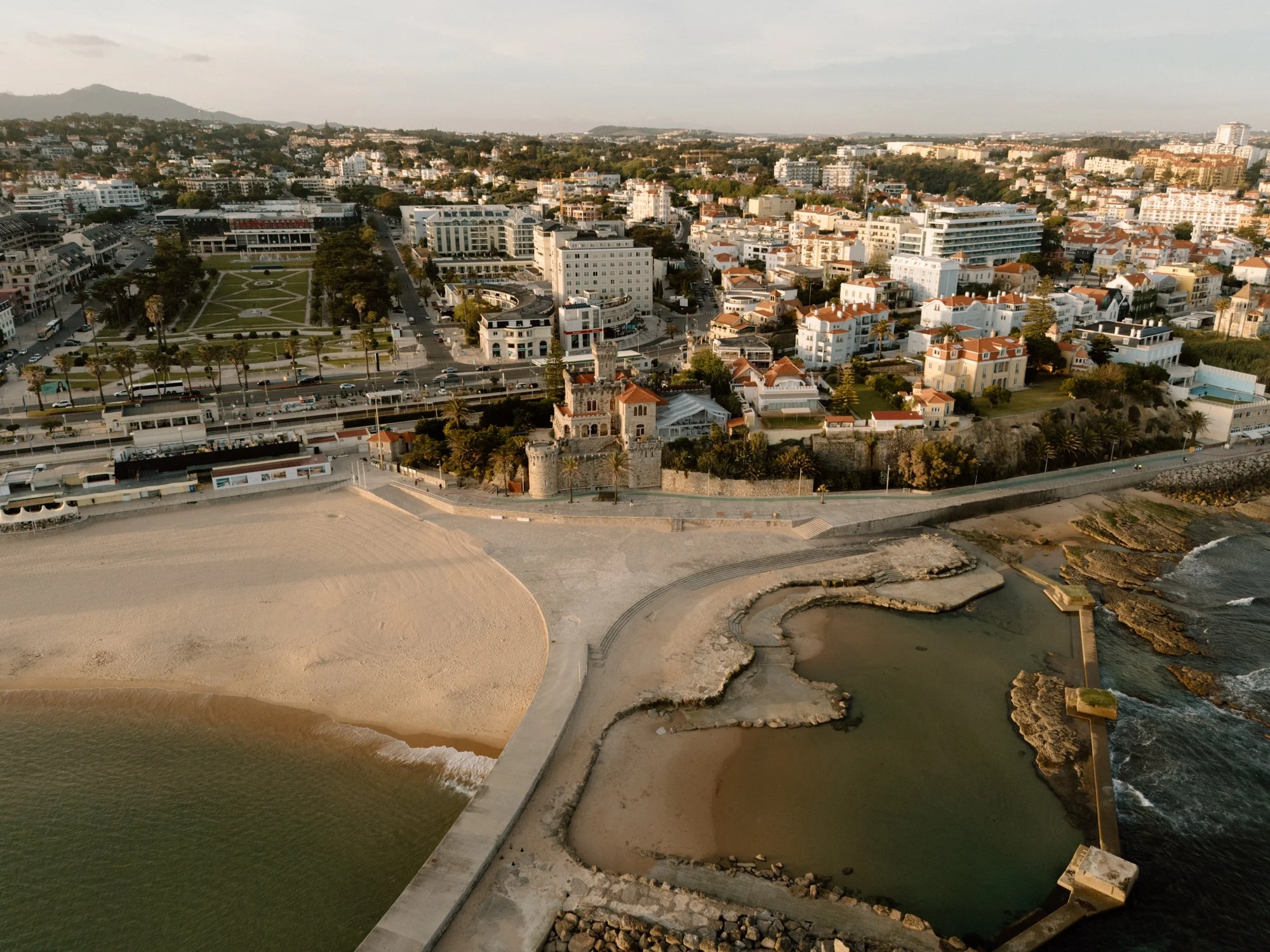 Aerial view of the Cascais coastline and forte da cruz near Lisbon Portugal at golden hour