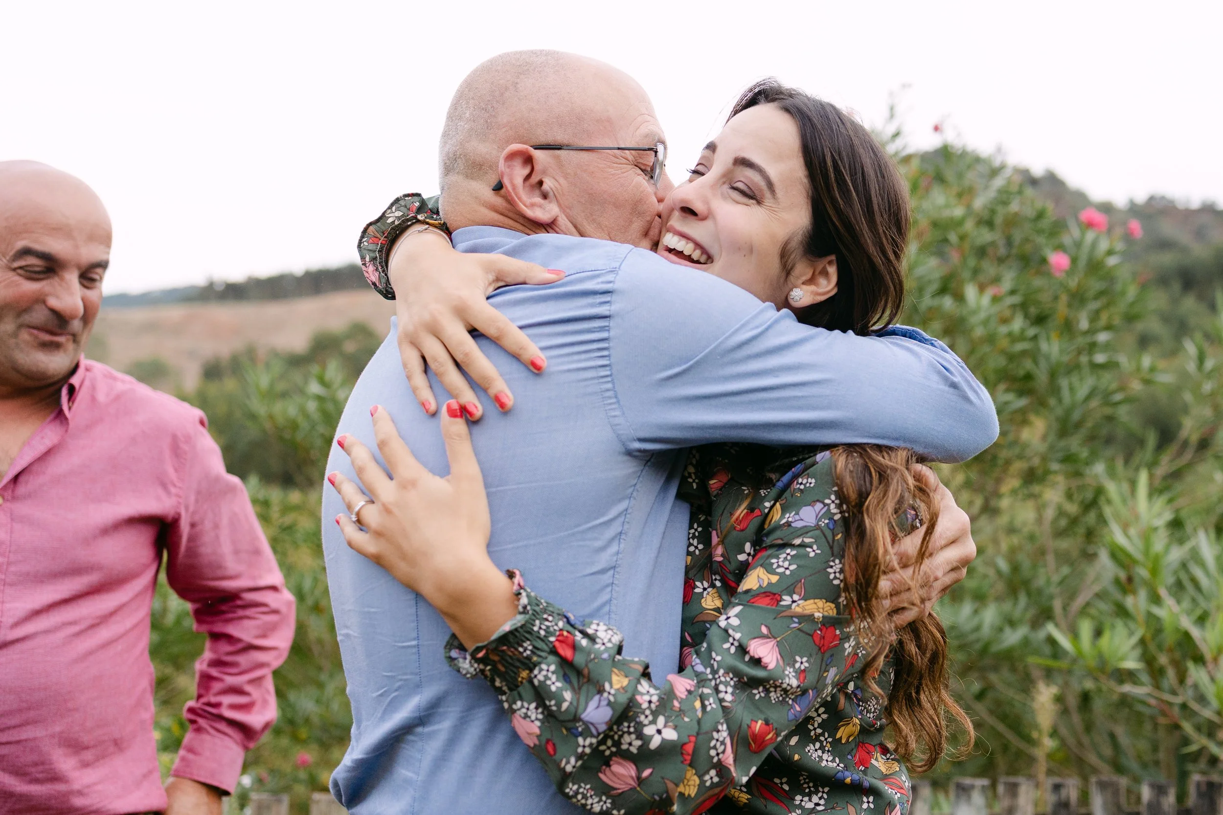Emotional family hug after surprise proposal celebration in Portugal