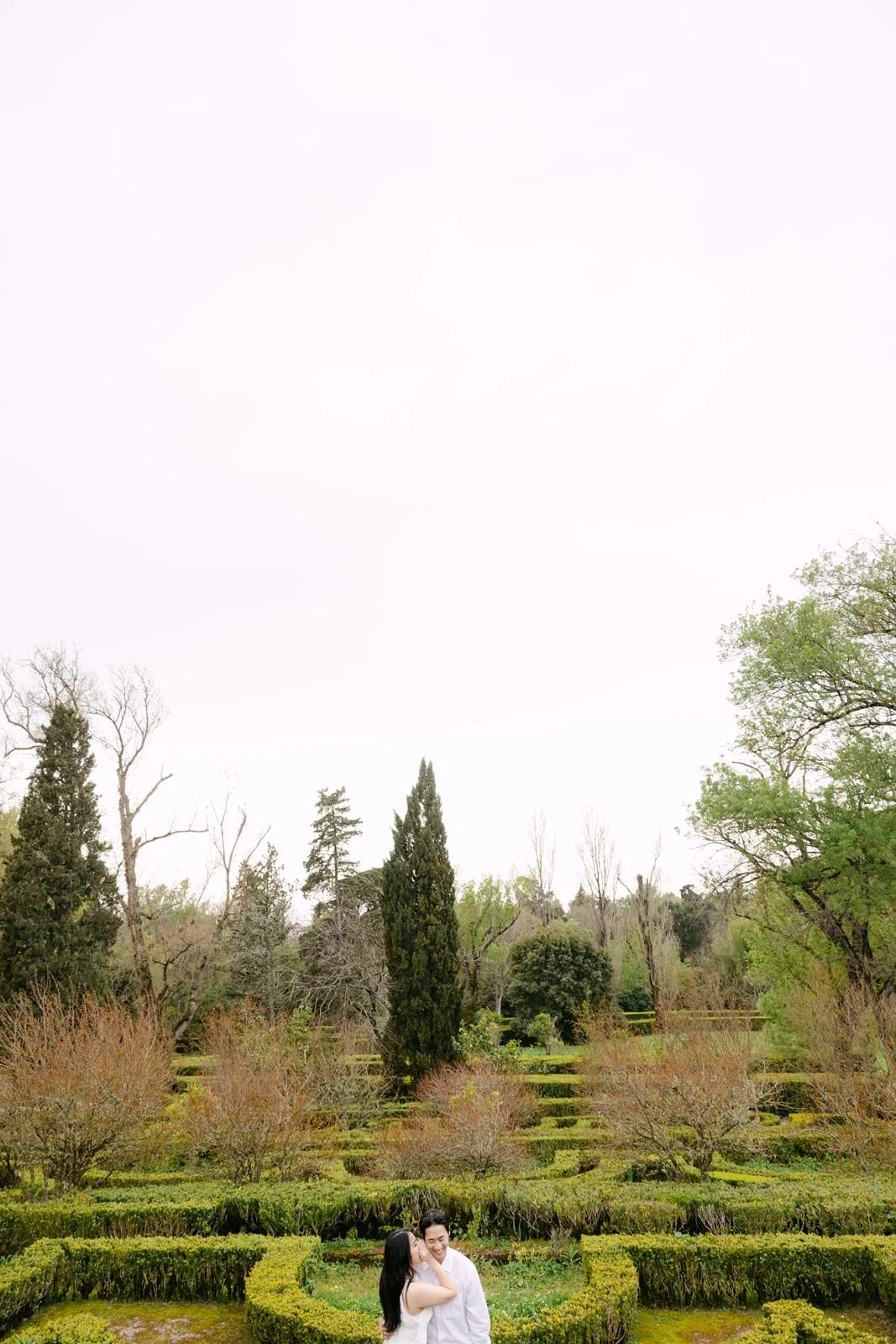 Romantic portrait of an engaged couple in the gardens of Palácio de Queluz near Lisbon.