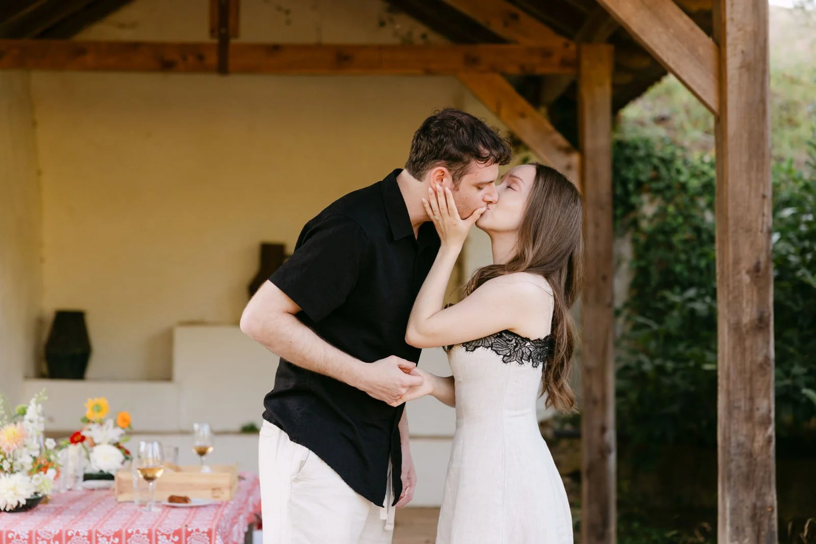 Newly engaged couple sharing their first kiss after a surprise marriage proposal and private picnic at Quinta de Sant’Ana near Lisbon.