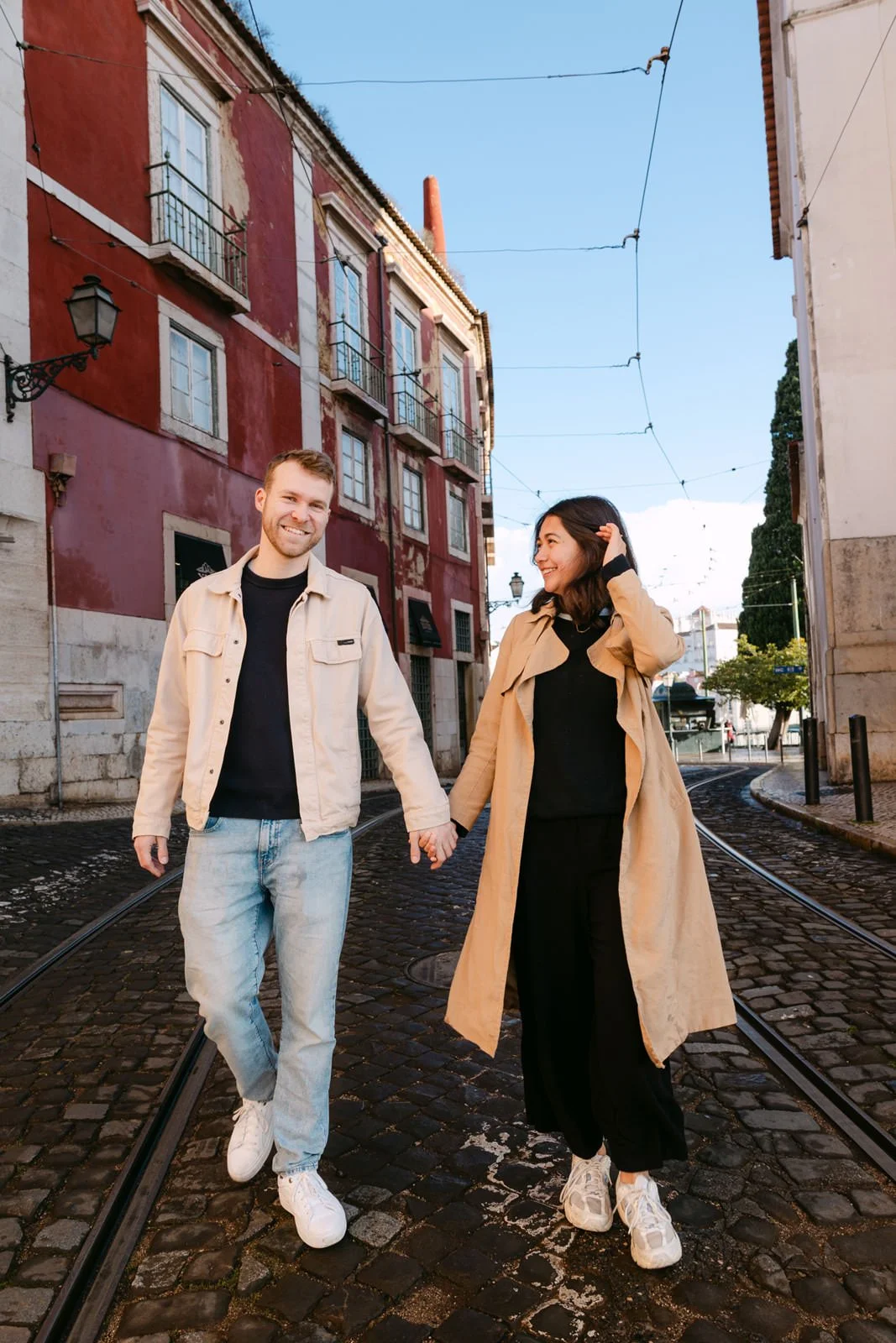 Couple walking through Alfama after their proposal in Lisbon